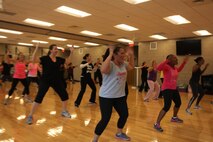 Daniela Lopez, zumba and fitness instructor at the fitness center aboard Marine Corps Air Station New River, leads a zumba fitness class designed to show healthy alternatives to smoking during the 2012 Great American Smoke Out, Nov. 15.