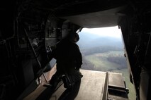 A crew chief with Marine Medium Tiltrotor Squadron 263 scopes out the area as he prepares to land in the fabricated country of Mica, Nov. 14. VMM-263 and Marine Corps Forces Special Operations Command Marines conducted “Operation Sundown”, a mock training event designed to simulate a mission while deployed.
