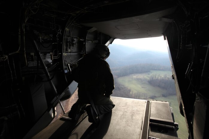 A crew chief with Marine Medium Tiltrotor Squadron 263 scopes out the area as he prepares to land in the fabricated country of Mica, Nov. 14. VMM-263 and Marine Corps Forces Special Operations Command Marines conducted “Operation Sundown”, a mock training event designed to simulate a mission while deployed.