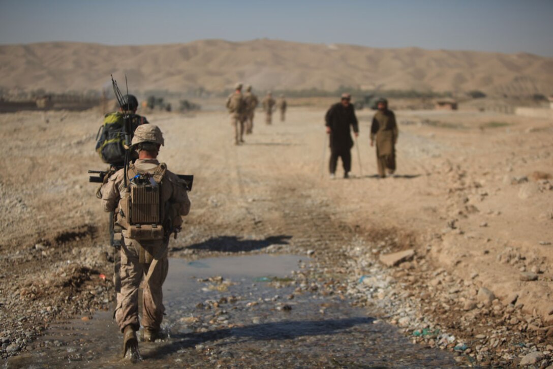 Marines with Golf Company, 2nd Battalion, 7th Marine Regiment, patrol through the construction site during Operation Golden Gate in Sangin, Afghanistan, Nov. 10, 2012. Golf Co. is tasked with providing security for the entire construction site along the Helmand River for the duration of the construction project.