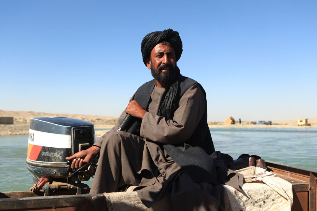 A local villager guides a ferry across the Helmand River, the easiest mode of transportation across the body of water. With the river cutting off easy access to the Sangin bazaar, a point of main commerce for the area, Operation Golden Gate was christened to change that. The first large operation in Regimental Combat Team 7â€™s area of responsibility calls for a bridge more than 150 feet long and 24 feet wide to be placed across the river.