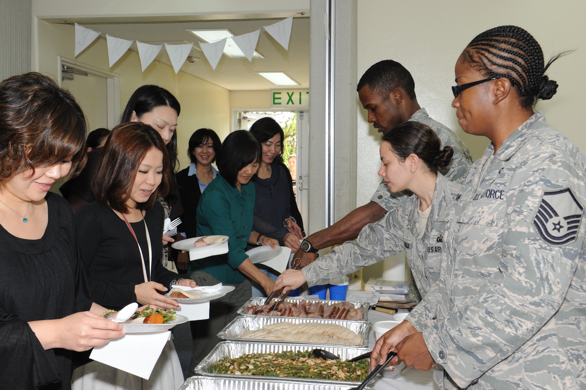 Kadena’s chapel team serves food to Japanese civilians at Chapel 1 on Kadena Air Base, Japan, Nov. 20, 2012. The first New England Thanksgiving was celebrated less than a year after Plymouth colonies settled in the new land in 1620. (U.S. Air Force photo/Airman 1st Class Malia Jenkins) 