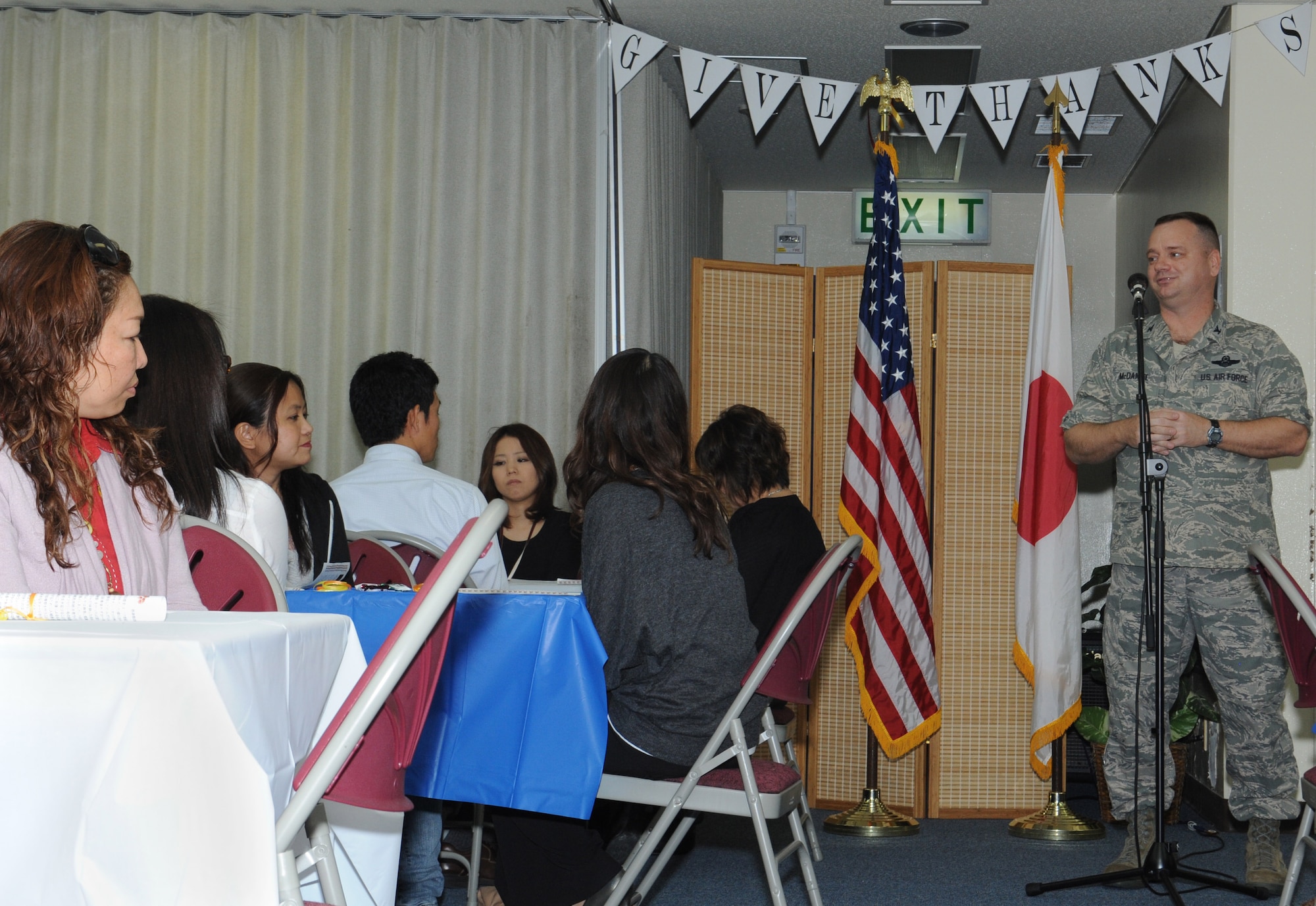 U.S. Air Force Col. Brian McDaniel, 18th Wing vice commander, talks to Japanese civilians at a Thanksgiving lunch on Kadena Air Base, Japan, Nov. 20, 2012. Chapel members held the lunch to show the Japanese civilians some Thanksgiving traditions like spending time with family and friends. (U.S. Air Force photo/Airman 1st Class Malia Jenkins)