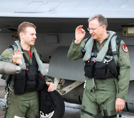 Capt. Tyler Smith, 36th Fighter Squadron pilot, goes over the capabilities of the F-16 Fighting Falcon with U.S. Ambassador to Singapore David Adelman before an incentive flight at Paya Lebar Air Base, Republic of Singapore, Oct. 19, 2012. The flight provided Adelman a better understanding of U.S. Air Force capabilities while the 36th Expeditionary Fighter Squadron was deployed during Operation Commando Sling 2012. (Courtesy photo)