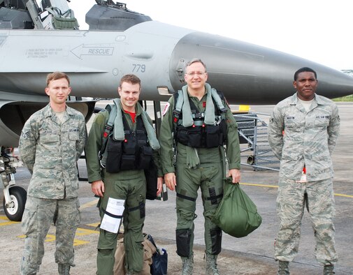 (Left to right) Senior Airman Joshua Page, Capt. Tyler Smith, U.S. Ambassador to Singapore David Adelman, and Airman 1st Class Martin Terrell, pose for a photo in front of an F-16 Fighting Falcon at Paya Lebar Air Base, Republic of Singapore, Oct. 19, 2012. The flight provided Adelman a better understanding of U.S. Air Force capabilities while the 36th Expeditionary Fighter Squadron was deployed during Operation Commando Sling 2012. Page is a 51st Aircraft Maintenance Squadron F-16 avionics journeyman, Smith is a 36th Fighter Squadron pilot, and Terrell is a 36th Aircraft Maintenance Unit crew chief. (Courtesy photo) 