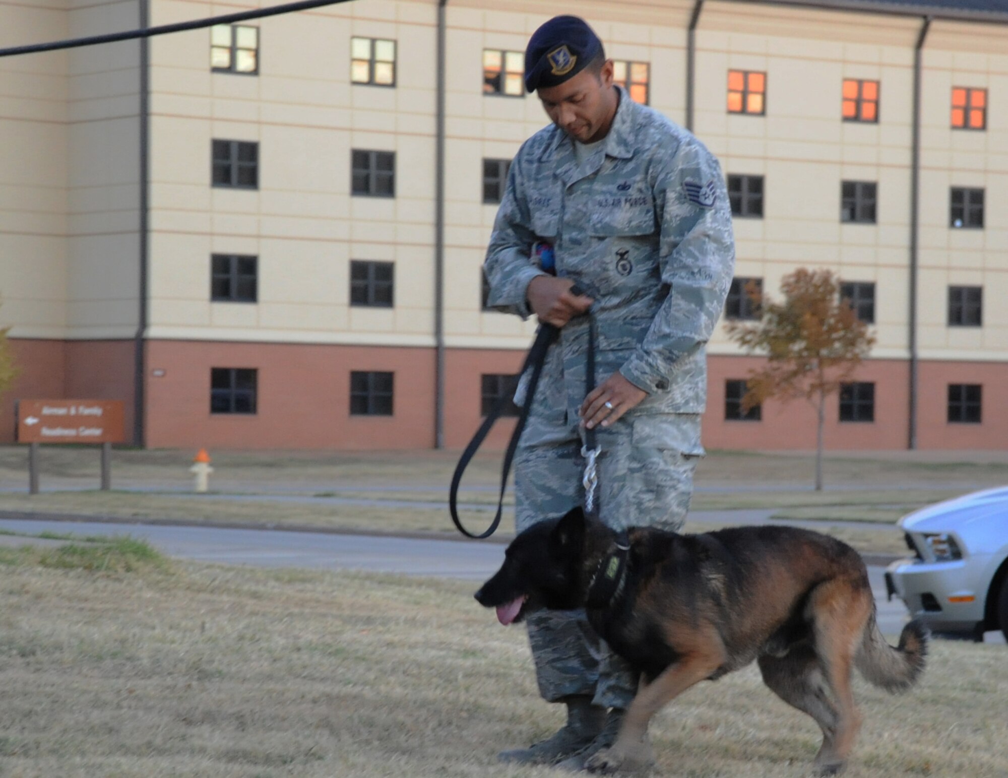 Staff Sgt. Daniel Flores and his military working dog Duck run through a series of obedience demonstrations for kids at the Airman & Family Readiness Center on Nov. 19. The event was part of a program to help highlight the importance of military working dogs and their handlers. (U.S. Air Force Photo/Kimberly Parker) 