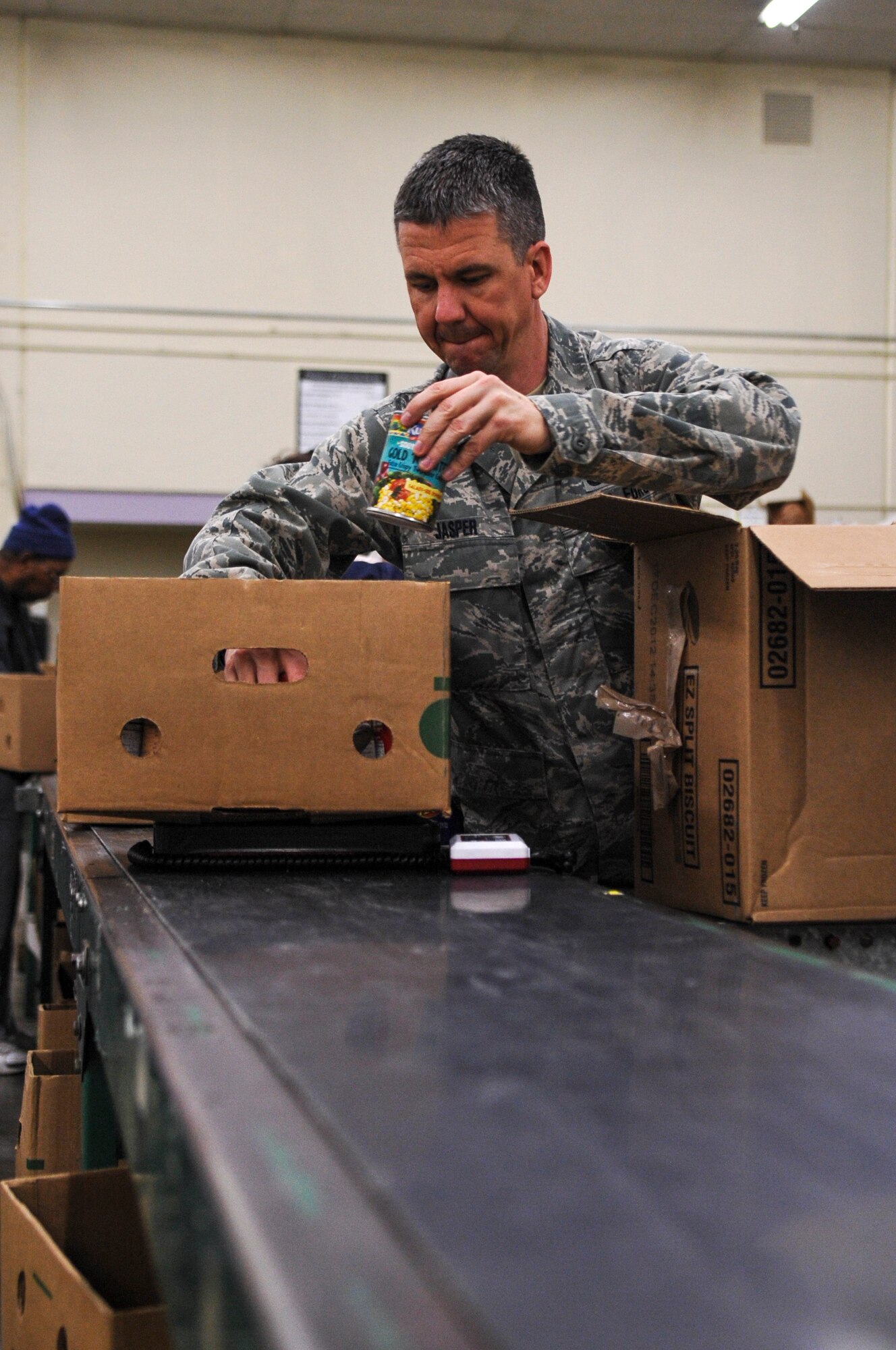 DENVER – Lt. Daniel Jasper, 460th Operations Group chief of standardization and evaluation, packs a box of food Nov. 19, 2012 while volunteering at the Food Bank of the Rockies. Jasper said Team Buckley is a part of the community so it’s important for them to get out and give back. (U.S. Air Force photo by Senior Airman Christopher Gross)