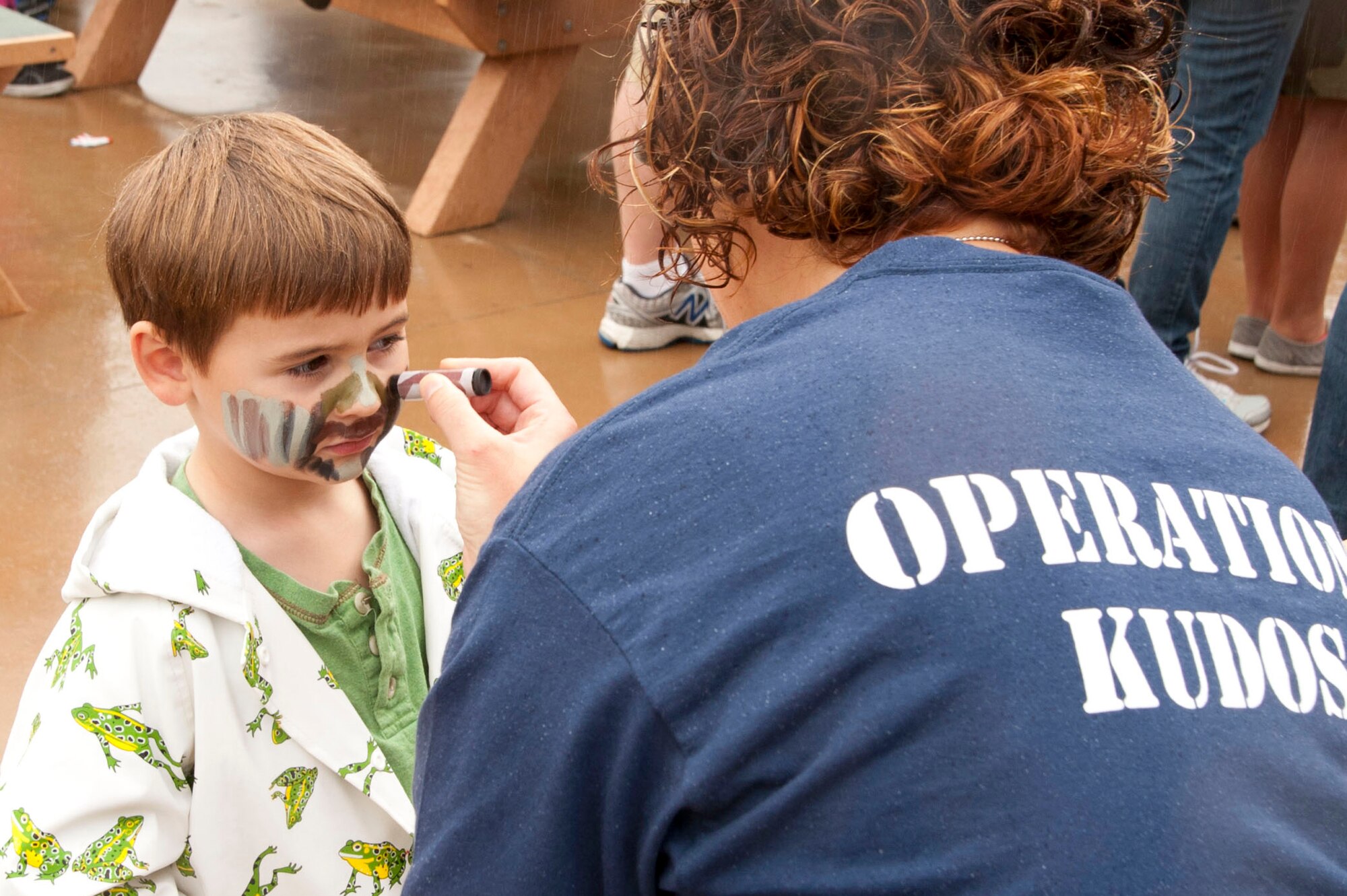 VANDENBERG AIR FORCE BASE, Calif. – Nicholas D’Alessio, Maj. Jason D’Alessio, Joint Functional Component Command for Space chief space situational awareness integration officer for the Joint Space Operations Center, gets his face painted during the Kids Understanding Deployments Operations event at Cocheo Park here Saturday, Nov. 17, 2012. KUDOS simulated a deployment processing line for dependents to help them understand the deployment process their parents or guardians go through before deployment. (U.S. Air Force photo/Senior Airman Lael Huss)