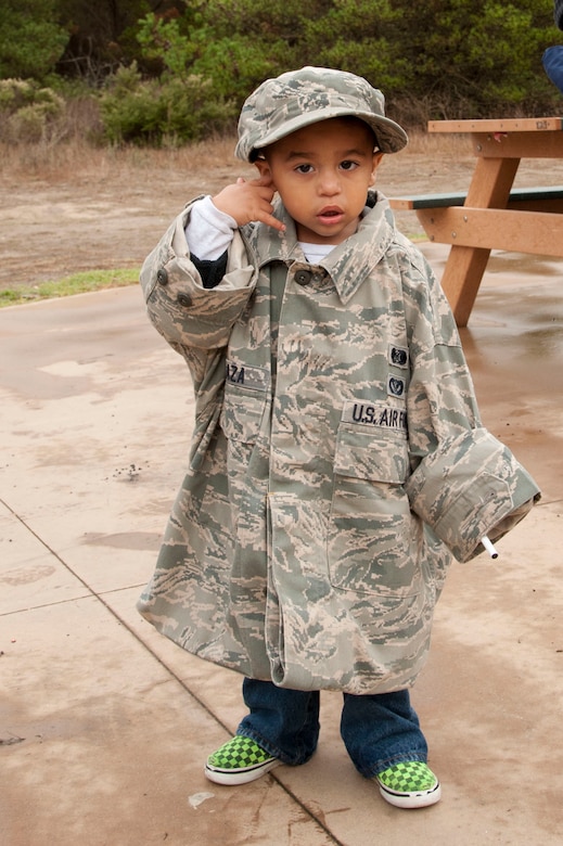 VANDENBERG AIR FORCE BASE, Calif. – Call me, I’m 2. Gabriel Peraza wears his father’s, Tech. Sgt. Angel Peraza, 30th Civil Engineer Readiness emergency manager, Airman’s Battle Uniform during a Kids Understanding Deployment Operations event at Cocheo Park here Saturday, Nov. 17, 2012. KUDOS simulated a deployment processing line for dependents to help them understand the deployment process their parents or guardians go through before deployment. (U.S. Air Force photo/Senior Airman Lael Huss)