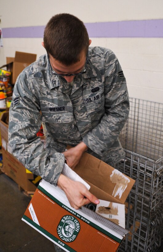 DENVER – Senior Airman Michael Wiesner, a 460th Operations Group volunteer from Buckley Air Force Base, disassembles a box Nov. 19, 2012 at the Food Bank of the Rockies. FBR is the largest private hunger-relief organization in the state of Colorado and nearly half of the food they distribute feeds children, according to their web site. (U.S. Air Force photo by Senior Airman Christopher Gross)