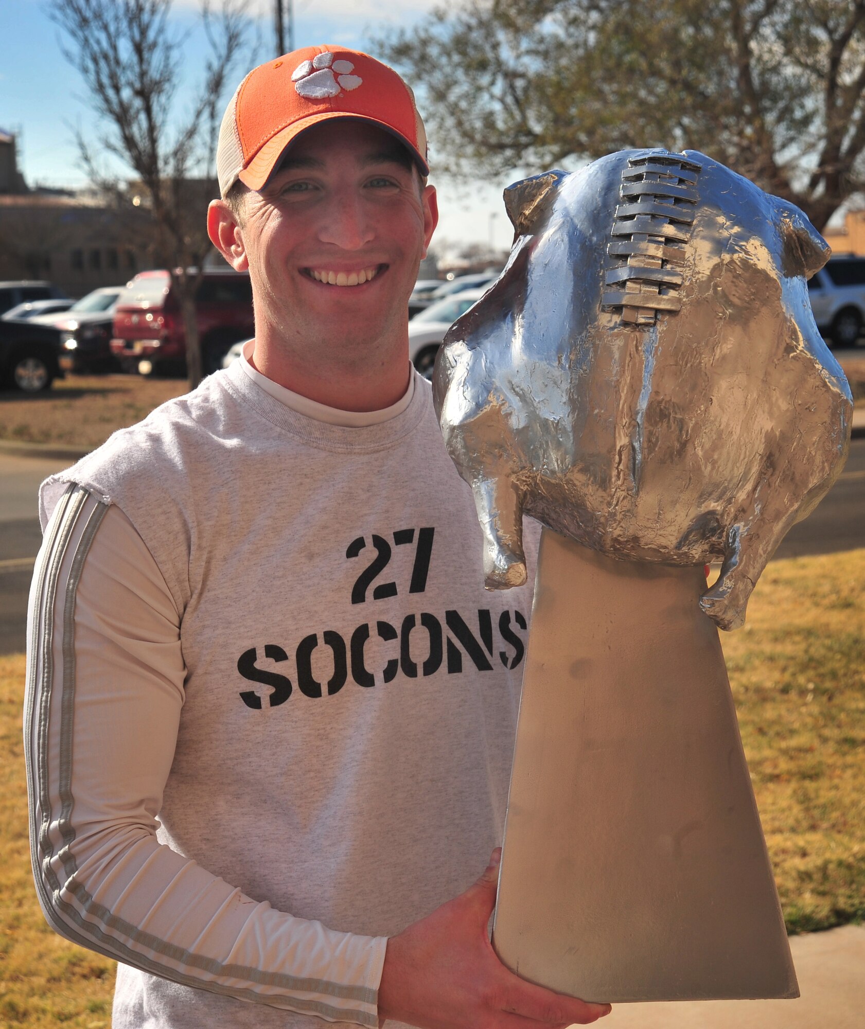 U.S. Air Force Staff Sgt. Timothy Ogburn, 27th Special Operations Contracting Squadron, proudly holds the Turkey Bowl trophy at Cannon Air Force Base, N.M., Nov. 16, 2012. The 27 SOCONS emerged victorious during this year's match. (U.S. Air Force photo/2nd Lt. Angelica Powell)    