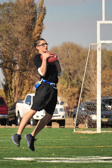 U.S. Air Force Airman 1st Class Ronald Bond, 27th Special Operations Comptroller Squadron, catches a pass during the second annual Turkey Bowl at Cannon Air Force Base, N.M., Nov. 16, 2012. The 27 SOCONS emerged victorious during this year's match. (U.S. Air Force photo/2nd Lt. Angelica Powell)    