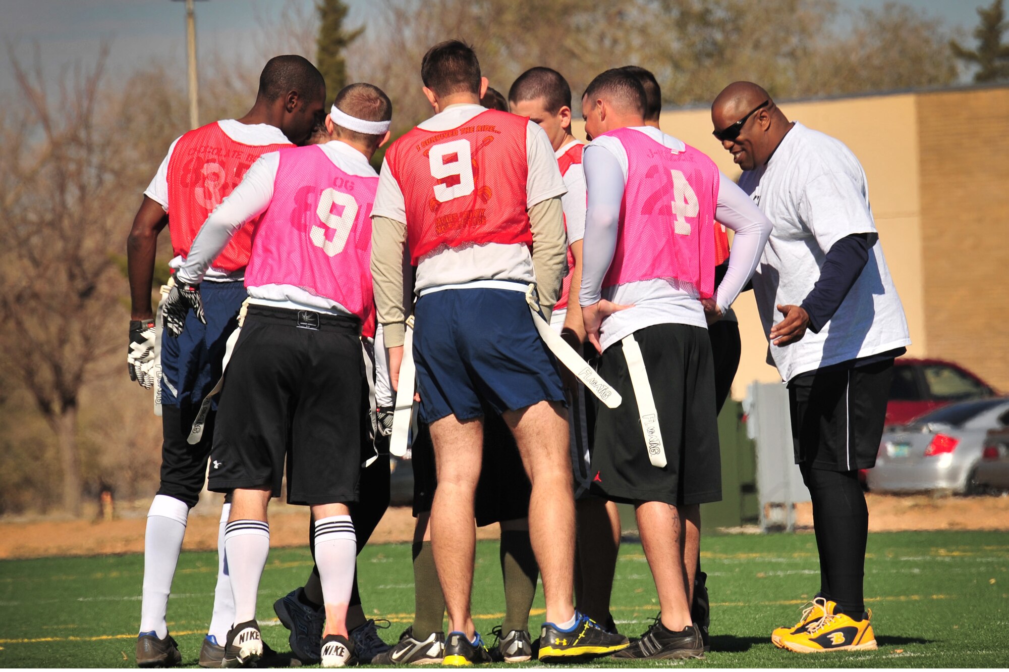 Members of the 27th Special Operations Contracting Squadron huddle up before kick-off on the football field near the Fitness Center at Cannon Air Force Base, N.M., Nov. 16, 2012. This was the second annual Turkey Bowl held at Cannon between the 27 SOCONS and the 27th Special Operations Comptroller Squadron. (U.S. Air Force photo/2nd Lt. Angelica Powell)    