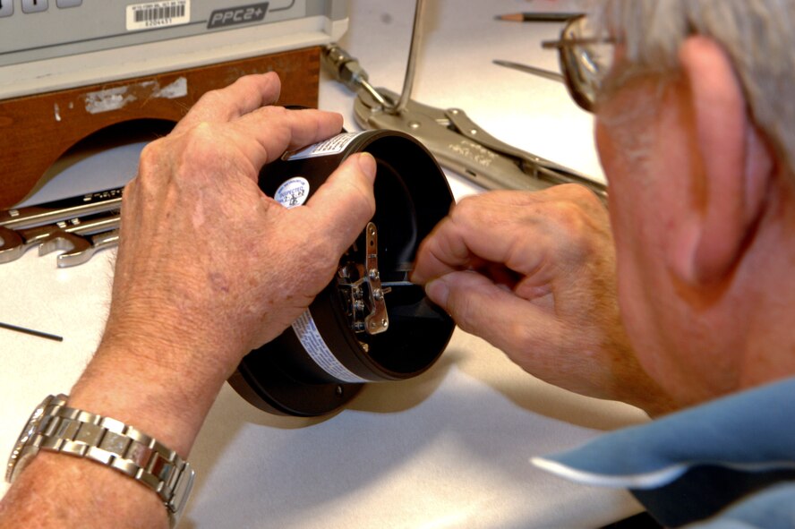 A technician at the Precision Measurement Equipment Laboratory make final adjustments on a pressure gauge used to monitor hydraulic pressure on Barksdale Air Force Base, La., Nov. 7. Technicians at the PMEL lab calibrate more than 7,500 pieces of test, measurement and diagnostic equipment that are used on the B-52H Stratofortress and other Air Force aircraft and support equipment. (U.S. Air Force photo/ Staff Sgt. Jason McCasland)(RELEASED)