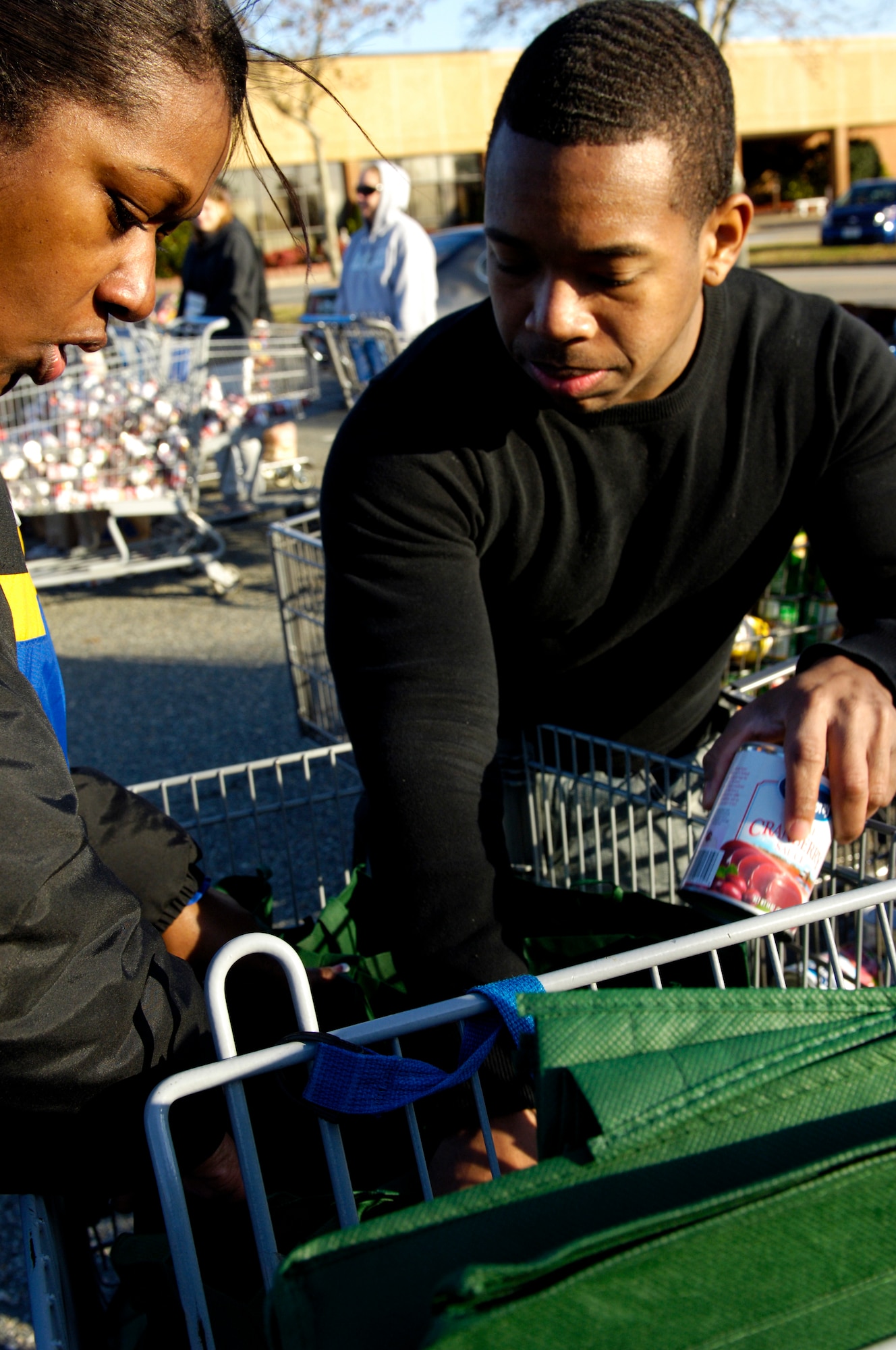 U.S. Air Force Senior Airman Reginald Tate, 633rd Medical Operation Squadron medical technician, helps organize food during Operation Warmheart at Langley Air Force Base, Va. Nov. 17, 2012. Operation Warmheart had multiple Airmen volunteer to help. (U.S. Air Force photo by Airman Kimberly Nagle/Released)

