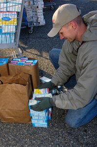 U.S. Air Force Master Sgt. Justin Phebus, 83rd Network Operations Squadron first sergeant, stacks boxes of donated food at Langley Air Force Base, Va. Nov. 17, 2012. Phebus, as part of the Langley First Sergeants Council, is supporting Operation Warmheart which helps Langley Airmen during the holidays. (U.S. Air Force photo by Airman Kimberly Nagle/Released) 