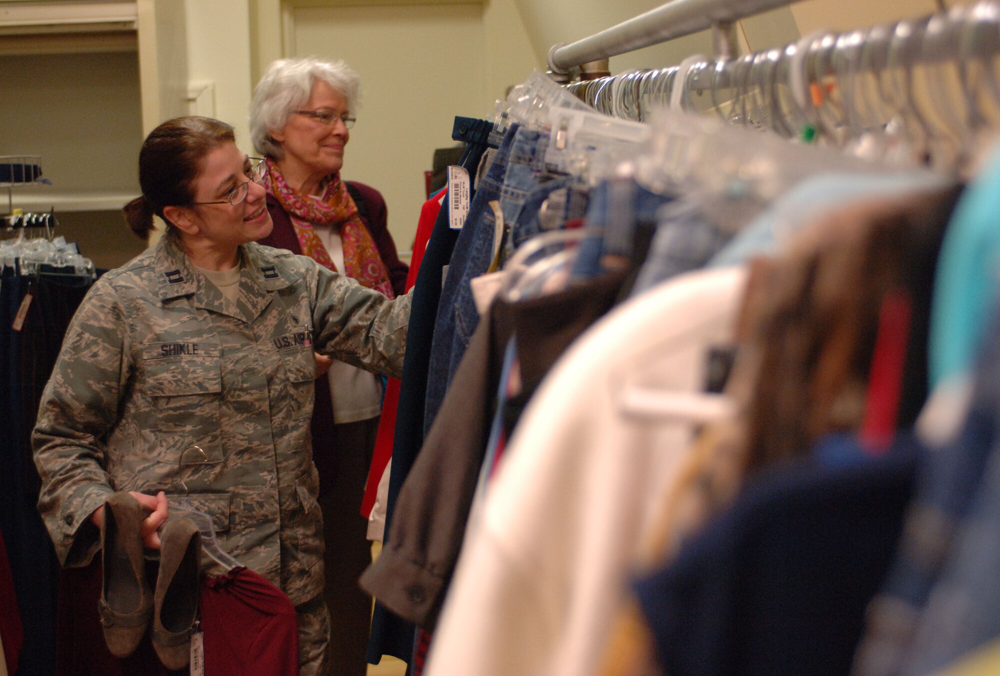 Captain Cristine Shikle and Carol Brown, 633rd Medical Operations Squadron personnel and repeat thrift shop customers, browse the clothing section at the Langley Thrift Shop, Nov. 16, 2012, at Langley Air Force Base, Va. By utilizing the consignment system, the thrift shop ensures that each item received is up to a high standard of quality. (U.S. Air Force photo by Airman 1st Class R. Alex Durbin/Released)