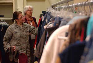 Captain Cristine Shikle and Carol Brown, 633rd Medical Operations Squadron personnel and repeat thrift shop customers, browse the clothing section at the Langley Thrift Shop, Nov. 16, 2012, at Langley Air Force Base, Va. By utilizing the consignment system, the thrift shop ensures that each item received is up to a high standard of quality. (U.S. Air Force photo by Airman 1st Class R. Alex Durbin/Released)