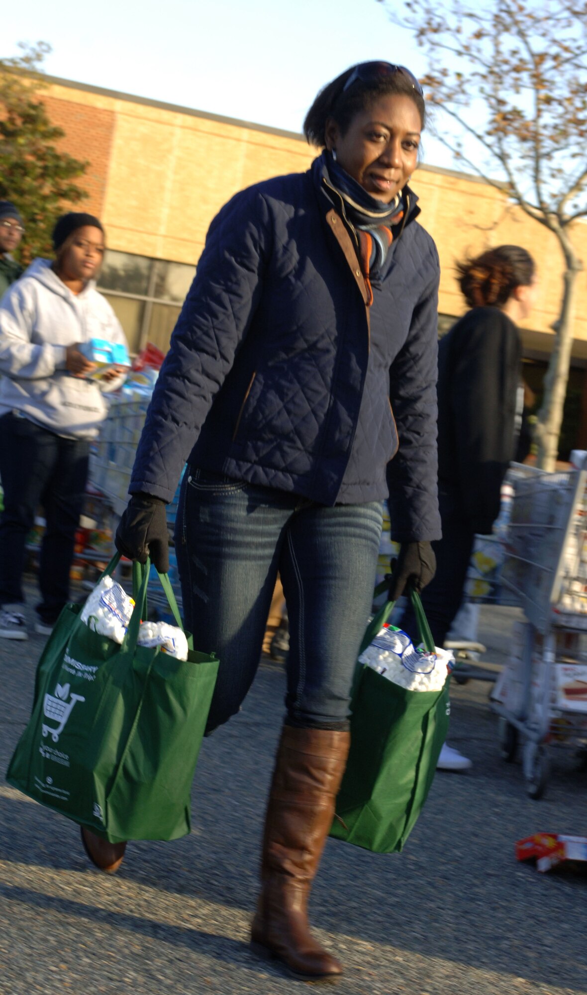 Master Sgt. Kendra Wilson, 30th Intelligence Squadron first sergeant, helps carry bags of Thanksgiving dinner; in support of Operation Warmheart Nov. 17, 2012, at Langley Air Force Base, Va. Money raised through 5K runs and donations allowed the Joint Base Langley-Eustis First Sergeant  ouncil to make roughly 550 food baskets for Airmen in need. (U.S. Air Force photo by Airman 1st Class R. Alex Durbin/Released)
