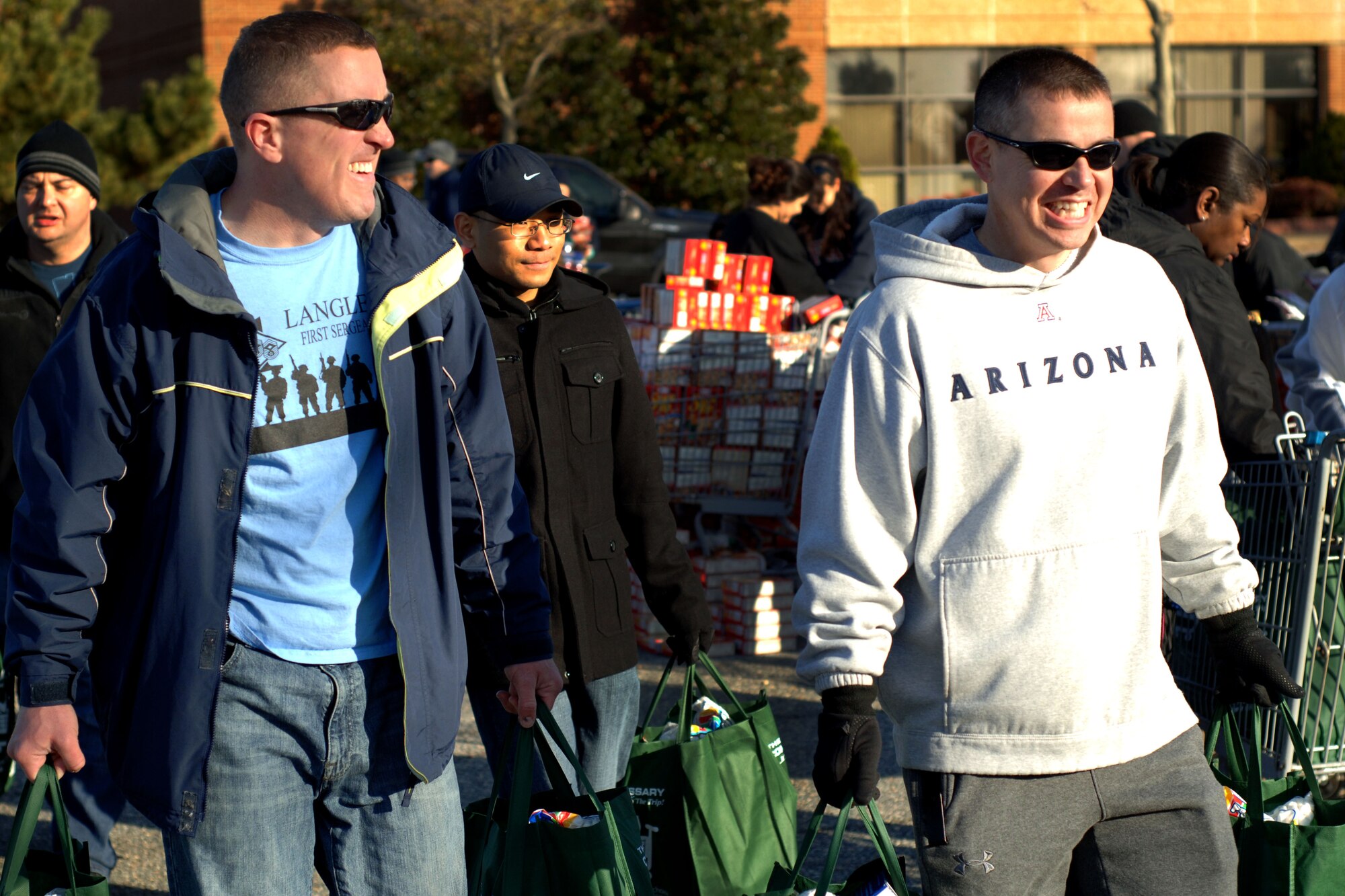 Volunteers carry bags of Thanksgiving dinners in support of Operation Warmheart Nov. 17, 2012, at Langley Air Force Base, Va. OWH’s main mission is to provide grants to Airmen in need. The Thanksgiving food basket give-away is the largest OWH event of the year. (U.S. Air Force photo by Airman 1st Class R. Alex Durbin/Released)