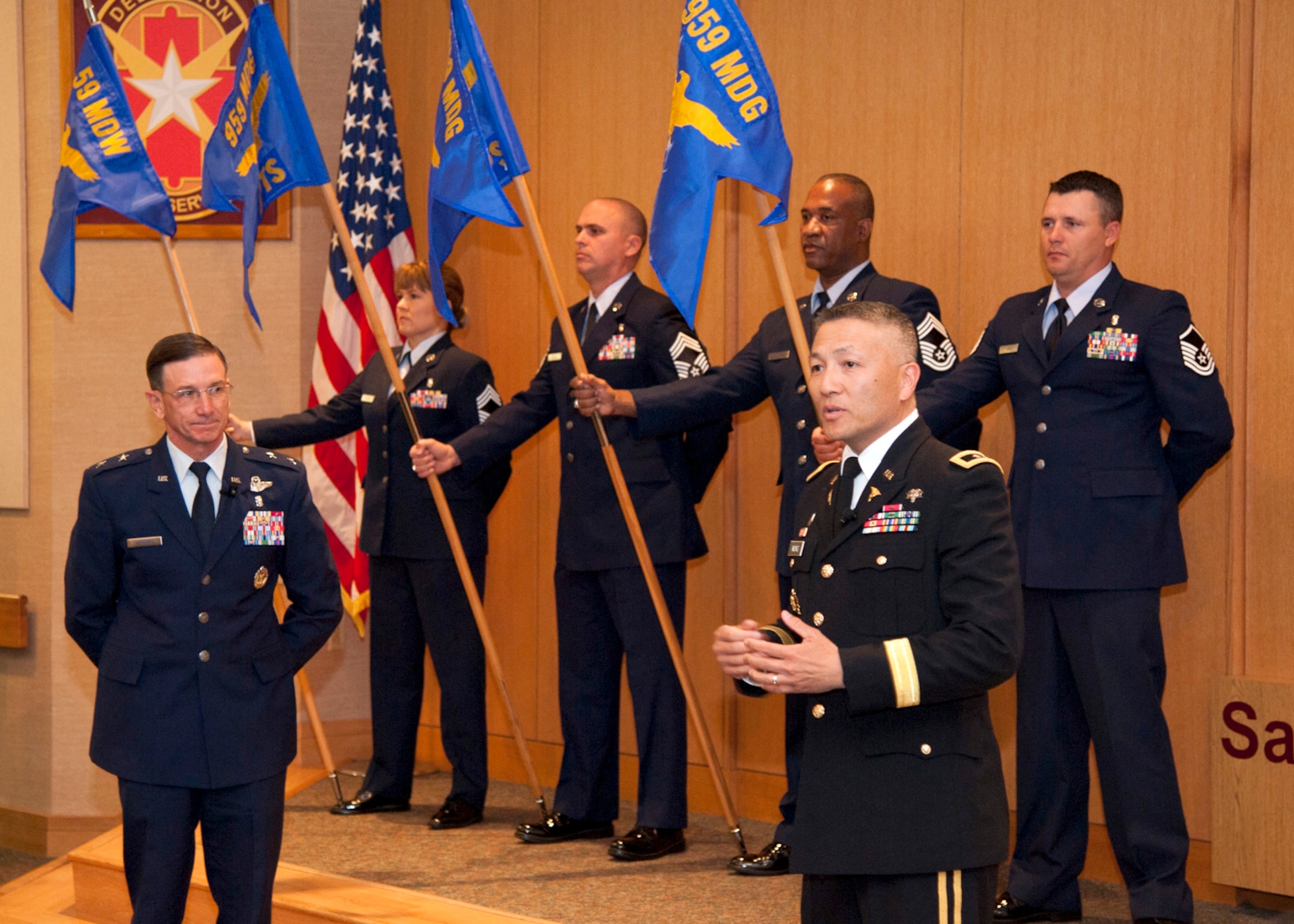 U.S. Air Force Maj. Gen. Byron Hepburn (front left) and U.S. Army Maj. Gen. Ted Wong (front right) speak during the 959th Medical Group activation ceremony at the San Antonio Military Medical Center, Joint Base San Antonio-Fort Sam Houston, Texas, Nov. 16. The move realigns medical services and administrative staff to provide better health care in the San Antonio Military Health System. Hepburn is commander of the 59th Medical Wing and director of the SAMHS. Wong is the commander of Brooke Army Medical Center and the SAMHS deputy director. (U.S. Air Force photo/Staff Sgt. Kevin Iinuma)