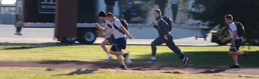 Barksdale Airmen run around the track during a rucksack relay race as a part of the 2012 Sports Day on Barksdale Air Force Base, La., Nov. 16. Airmen participated in activities such as dodgeball, soccer, basketball, a rucksack relay race, volleyball, flag football and a homerun derby. Sports Day served as a way to promote the importance of fitness and build camaraderie. (U.S. Air Force photo/Airman 1st Class Andrew Moua)(RELEASED)