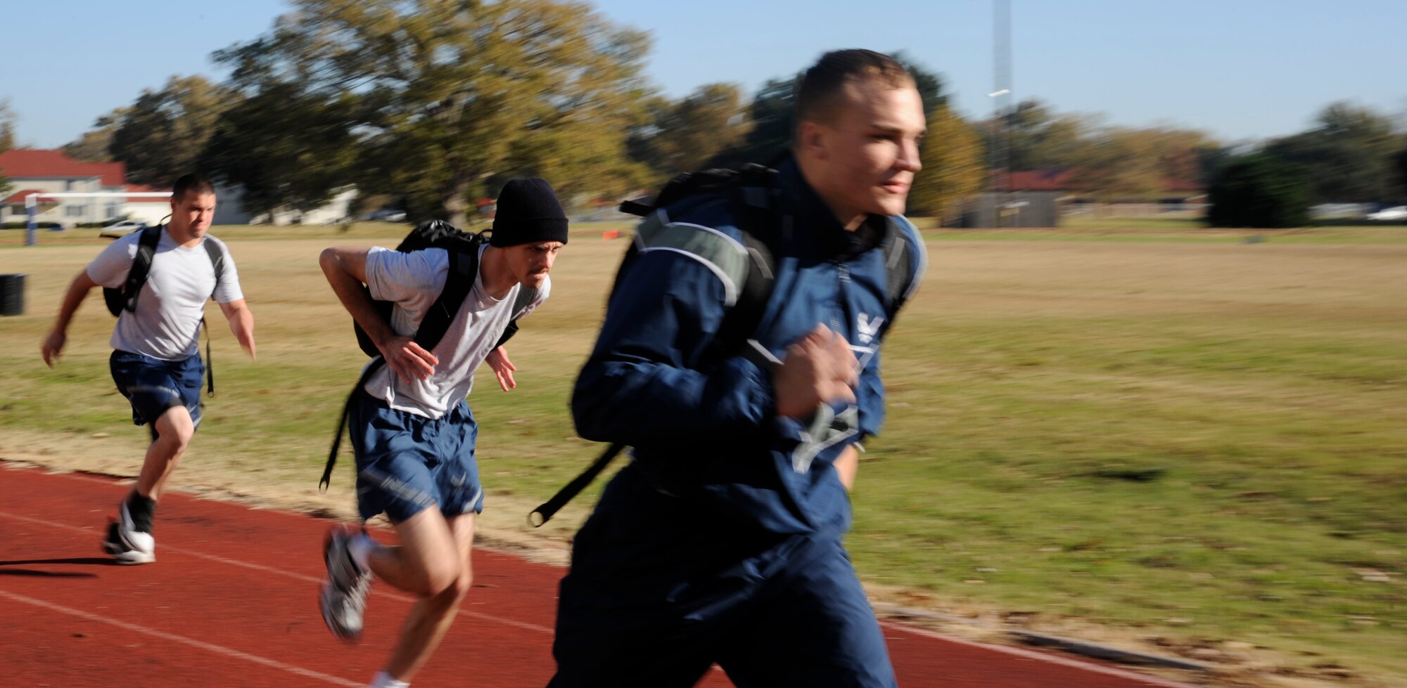 Barksdale Airmen run around the track during a rucksack relay race as a part of the 2012 Sports Day on Barksdale Air Force Base, La., Nov. 16. This annual event gives Airmen the opportunity to participate in several individual and team sports throughout the day boosting morale. (U.S. Air Force photo/Airman 1st Class Andrew Moua)(RELEASED)