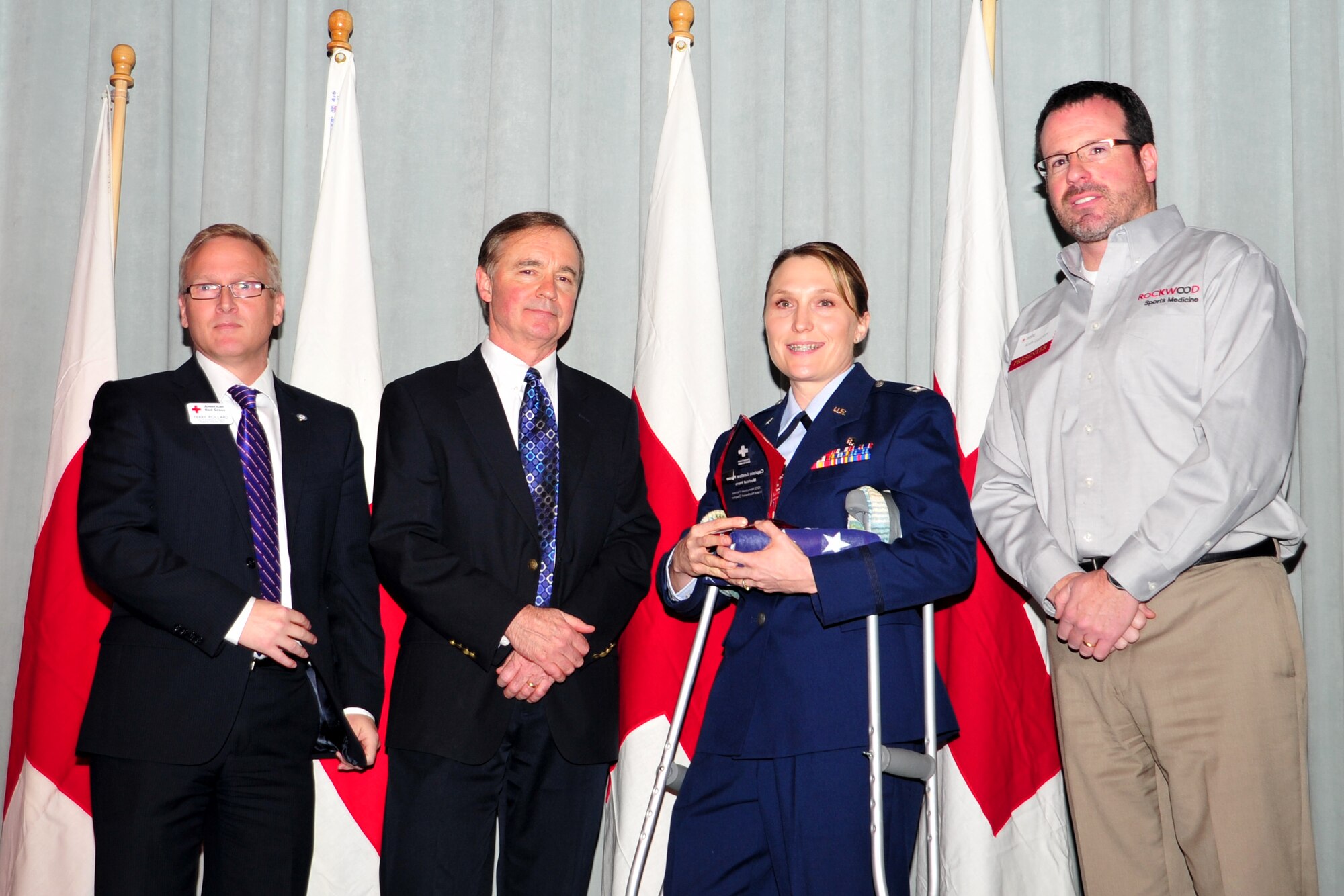 Capt. (Dr.) Leslee Kane accepts the Medical Hero award at the Hometown Heroes luncheon, Nov. 15, 2012. The American Red Cross awards individuals who have made a positive impact on the lives of others, whether through a life-saving action or tireless effort to benefit the community. Kane is with the 92nd Medical Operations Squadron. (U.S. Air Force photo by Airman 1st Class Taylor Curry)