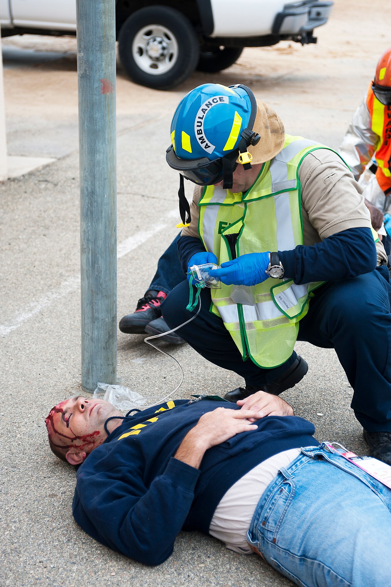 First responders treat an injured man with head wounds.  Volunteers from Team Edwards put on fake trauma wounds to simulate injuries that medics need to treat.  (U.S. Air Force photo by Ethan Wagner)