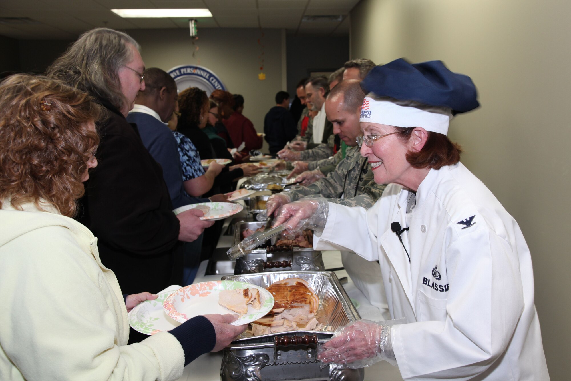 Col. Pat Blassie, Air Reserve Personnel Center commander, serves Gwen Coleman and Gerry Jackson, during the annual ARPC Thanksgiving luncheon held Nov. 14, 2012, at the ARPC headquarters on Buckley Air Force Base, Colo. (U.S. Air Force photo/Quinn Jacobson)
