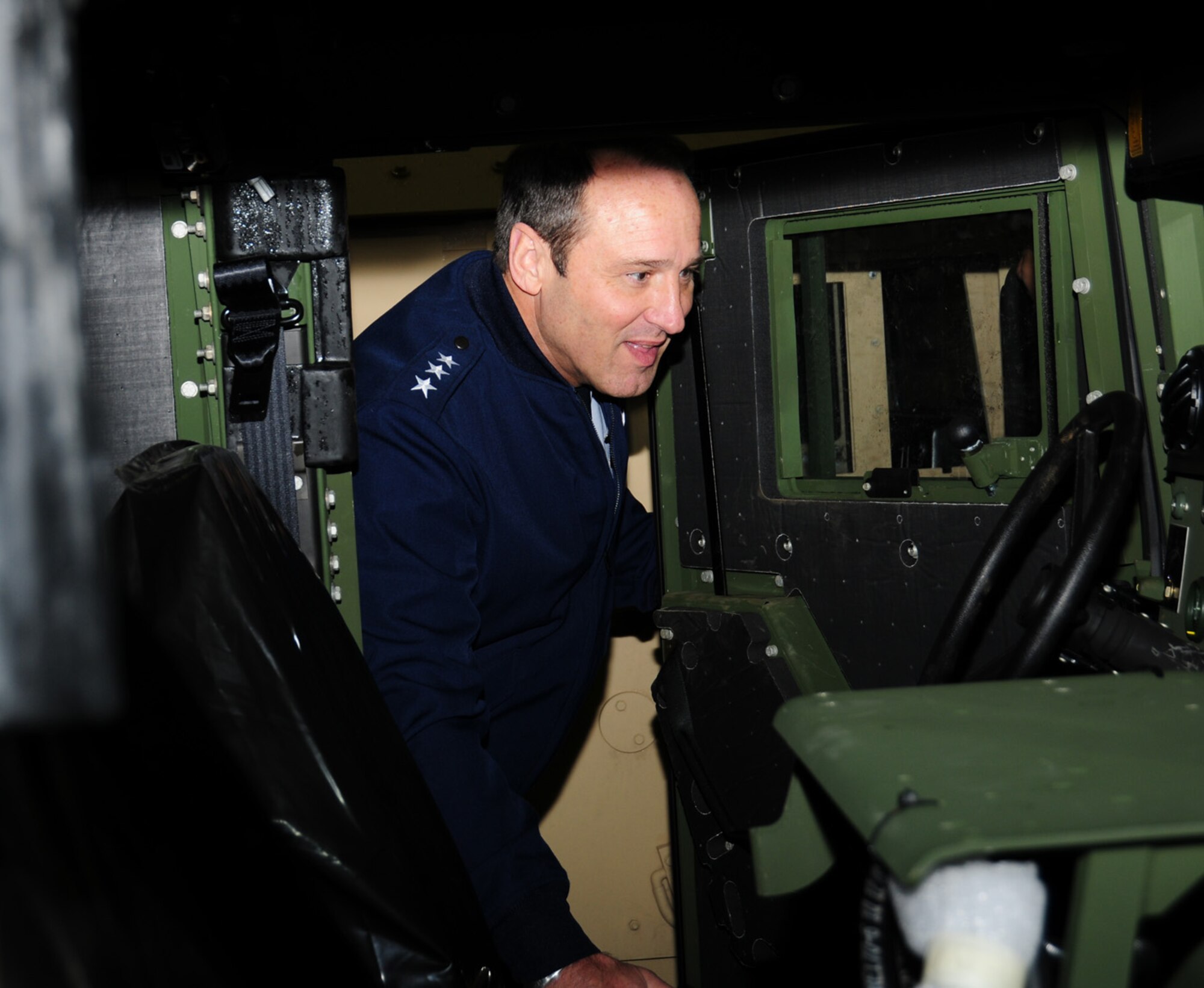 Lt. Gen. N. Tom Jones, U.S. Air Forces in Europe vice commander, Ramstein Air Base, Germany,  looks inside a HUMVEE at the 100th Logistics Readiness Squadron Vehicle Maintenance facility Nov. 19, 2012, at RAF Mildenhall, England. While here, the general met with group, squadron and base leadership, and other military and civilian members from around base. Jones also visited RAF Lakenheath. (U.S. Air Force photo by Karen Abeyasekere/released)
 
