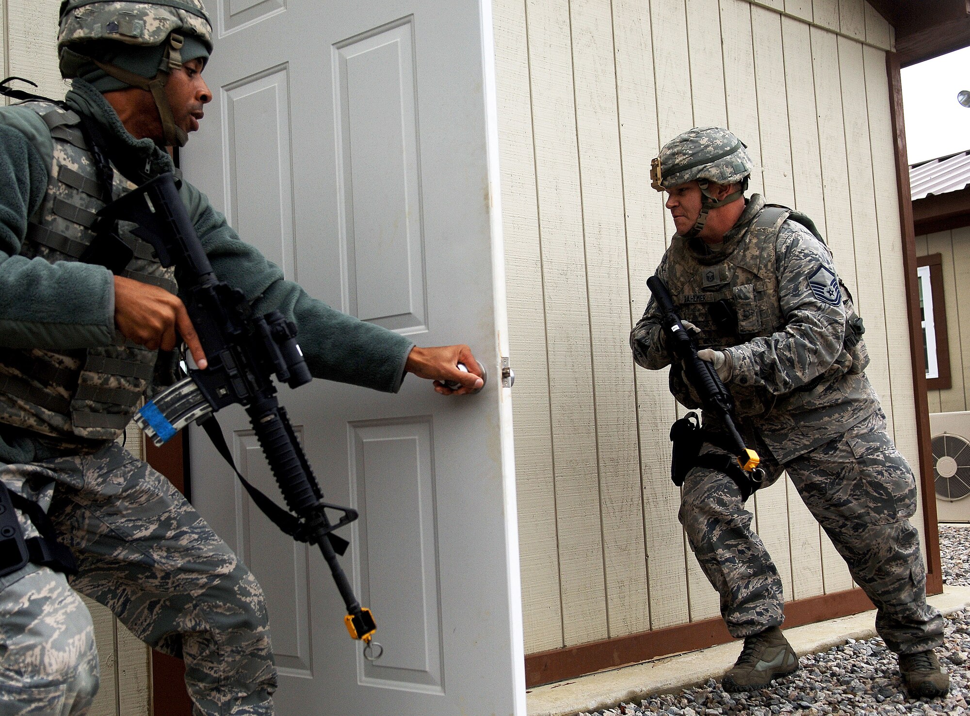 Staff Sgt. Ervin Faison (left) and Master Sgt. Jon Dahlmer (right), 633rd Security Forces Squadron personnel, clear buildings after responding to an active shooter exercise at Langley Air Force Base, Va., Nov. 15, 2012.  Dahlmer said his first priority during a situation like this is to neutralize the threat, and get anyone who isn’t injured out of the area. (U.S. Air Force photo by Staff Sgt. Katie G. Ward / Released)