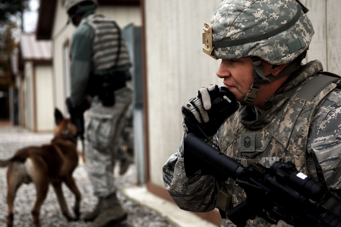 Master Sgt. Jon Dahlmer, 633rd Security Forces Squadron flight chief of A-flight, communicates with his team after responding to an active shooter during an exercise at Langley Air Force Base, Va., Nov. 15, 2012.  Dahlmer said that even during a training exercise, practicing like it’s a real situation is the most effective way to make the right decisions. (U.S. Air Force photo by Staff Sgt. Katie G. Ward / Released)
