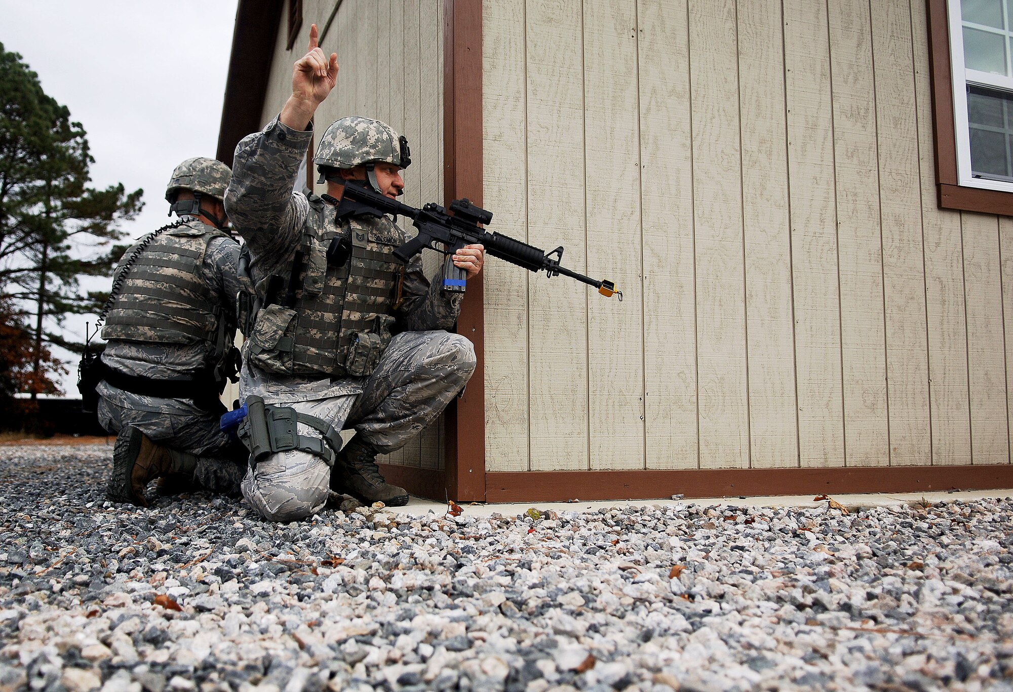 Tech Sgt. Richard Solomon, 633rd Security Forces flight chief of A-flight, signals to his team members during an active shooter exercise at Langley Air Force Base, Va., Nov. 15, 2012. The exercise involved responses from security forces, the fire department and medical personnel.  (U.S. Air Force photo by Staff Sgt. Katie G. Ward / Released) 