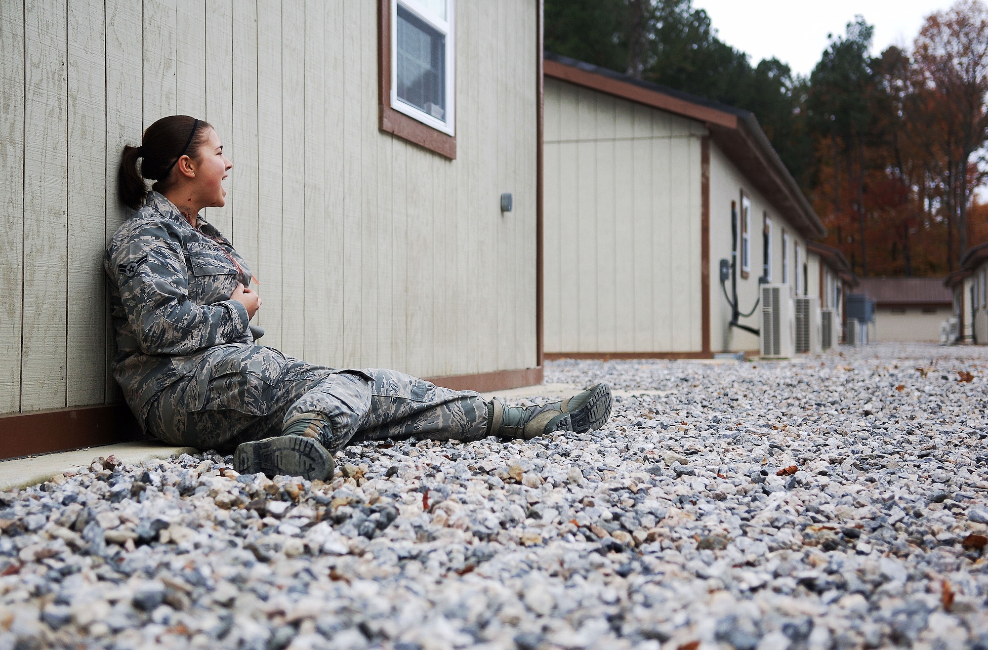Airman First Class Erica Crowder, 633rd Surgical Services Squadron aerospace medical services technician, yells for help after she suffered a simulated injury during an active shooter exercise at Langley Air Force Base, Va., Nov. 15, 2012.  The exercise involved responses from security forces, the fire department and medical personnel.  (U.S. Air Force photo by Staff Sgt. Katie G. Ward / Released)