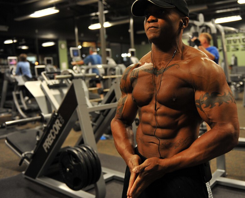 U.S. Air Force Master Sgt. LaJuan Fuller, 366th Civil Engineer Squadron first sergeant, practices posing to music he selected for his upcoming body-building competition to ensure his timing and poses are proper in Mountain Home, Idaho, April 25, 2012. Fuller uses has a membership at a gym off base which allows him to take his shirt off while practicing his poses and utilize a tanning bed to even out his tan lines before competitions. (U.S. Air Force photo/Airman 1st Class Heather Hayward)