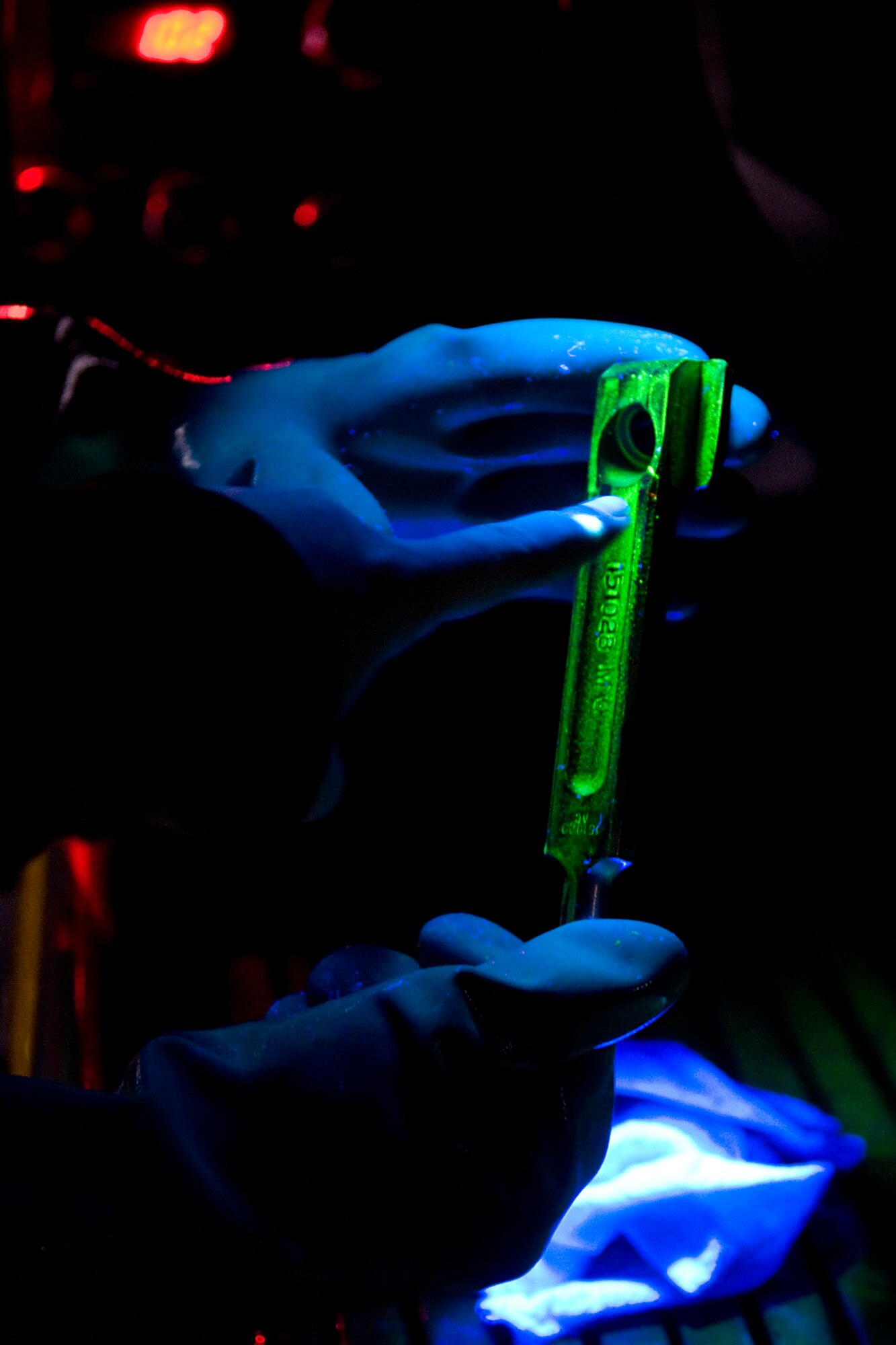 Master Sgt. Valerie Nelson, 434th Maintenance Squadron nondestructive inspection noncommissioned officer in charge, uses a magnetic particle inspection device to find cracks in a main wheel rotor drive key during an honorary commander tour of Grissom's maintenance facilities held for Grissom's honorary commanders recently. (U.S. Air Force photo/ Tech. Sgt. Mark Orders-Woempner)
