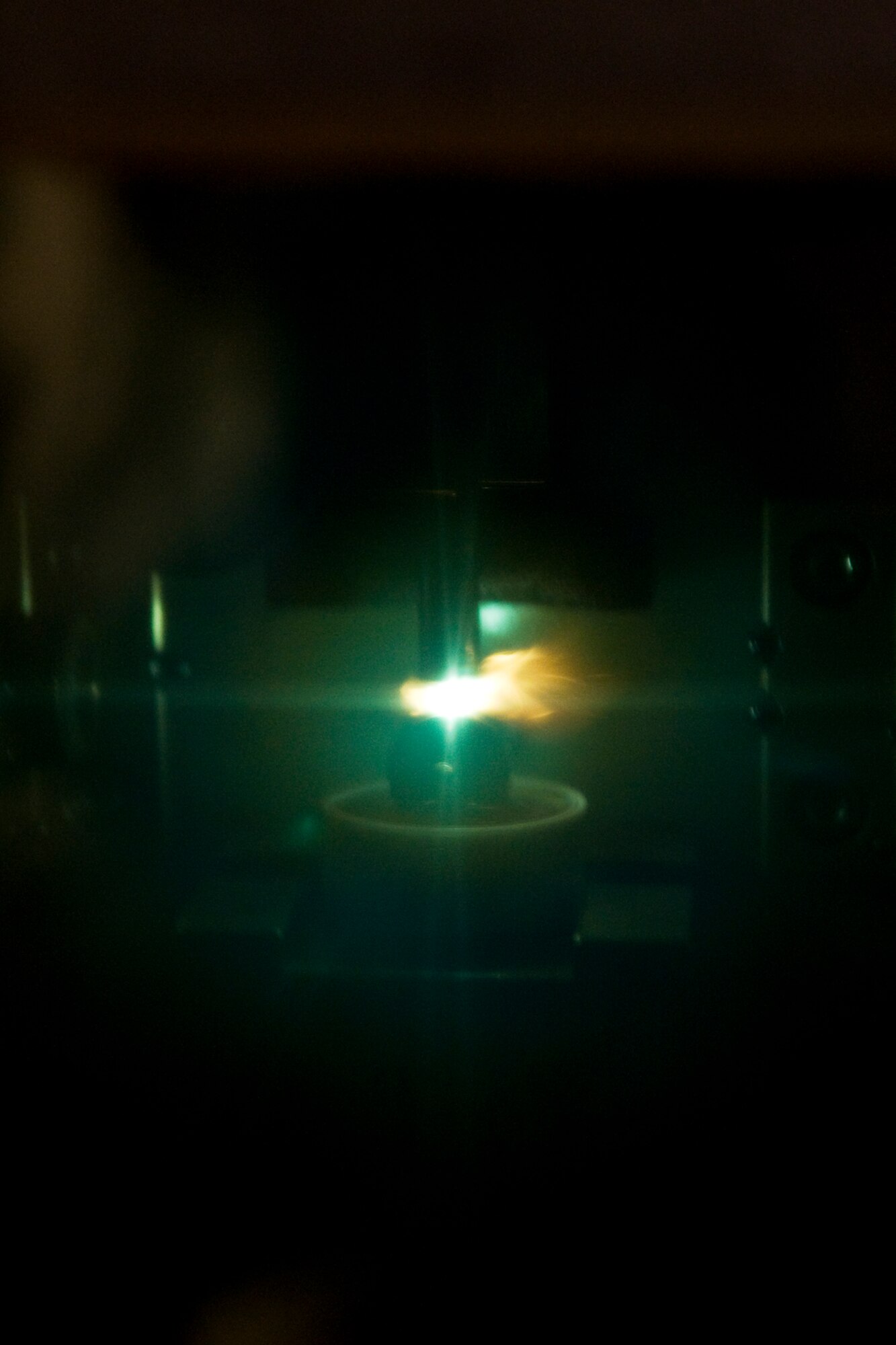 A spectrometric oil analysis machine burns used engine oil from a KC-135R Stratotanker. Grissom honorary commanders got to see the machine here recently, which examines the different contents in used engine oil to determine what might be breaking down inside an aircraft engine. (U.S. Air Force photo/ Tech. Sgt. Mark Orders-Woempner)
