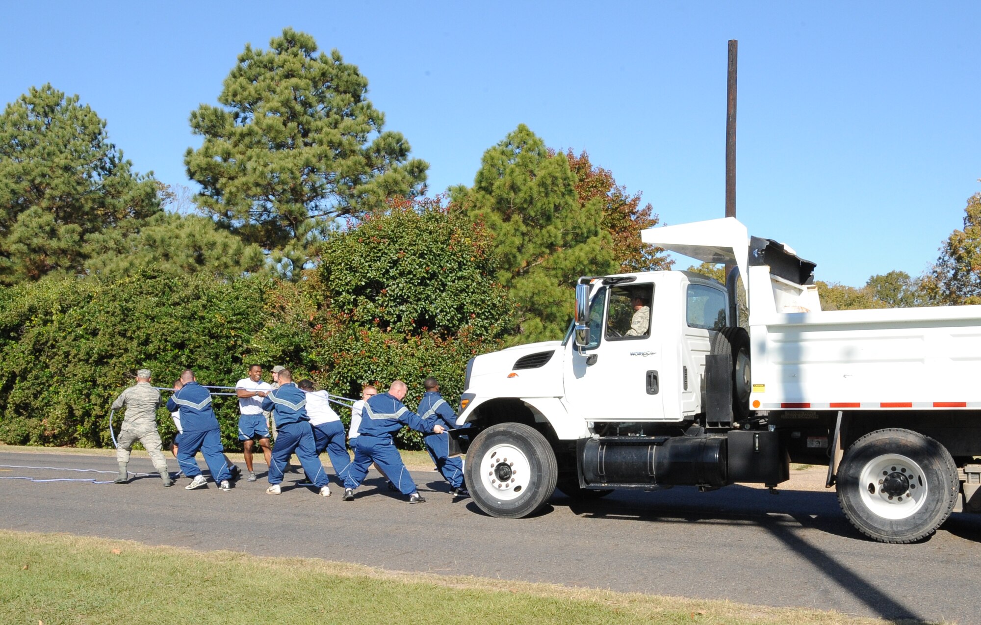 Airmen from the 2nd Civil Engineer Squadron pull a dump truck during the 2012 Sports Day on Barksdale Air Force Base, La., Nov. 16. Sports Day consisted of various team events including dodgeball, basketball, soccer, tug-of-war, volleyball, a homerun derby, flag football and racquetball. This day was designed to improve teamwork, and help increase the awareness of fitness, sports programs and boost morale. (U.S. Air Force photo/Airman 1st Class Benjamin Gonsier)(RELEASED)
