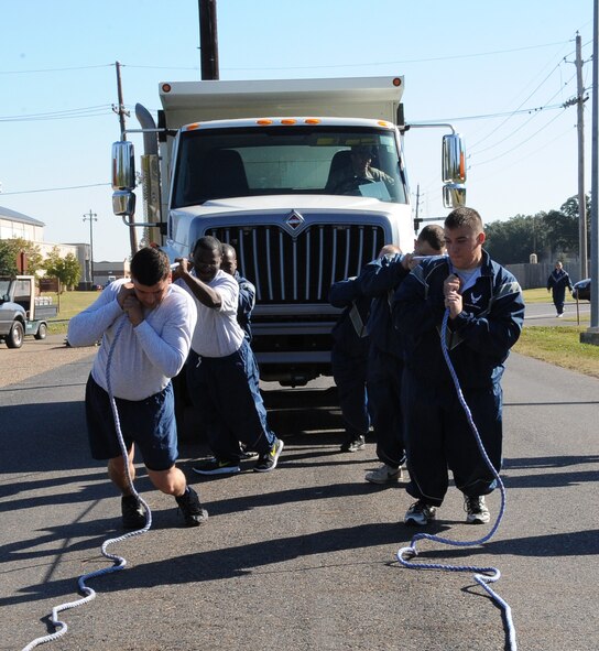Airmen from the 2nd Civil Engineer Squadron pull a dump truck during the 2012 Sports Day on Barksdale Air Force Base, La., Nov. 16. The annual event gave Airmen the opportunity to participate in several individual and team sports throughout the day boosting morale. (U.S. Air Force photo/Airman 1st Class Benjamin Gonsier)(RELEASED)
