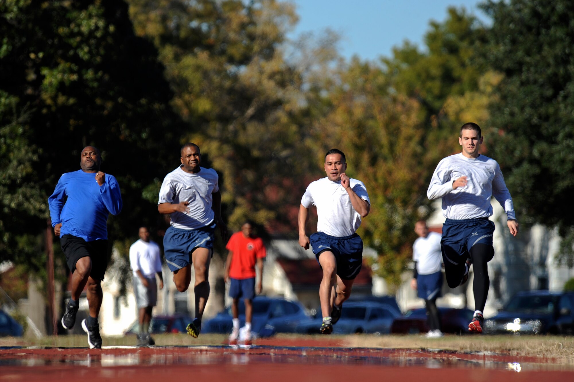 Participants run for the finish line during the 2012 Sports Day 100-meter dash on Barksdale Air Force Base, La., Nov. 16. Sports Day is comprised of various competitive athletic events to help promote physical fitness. (U.S. Air Force photo/Senior Airman Micaiah Anthony)(RELEASED)