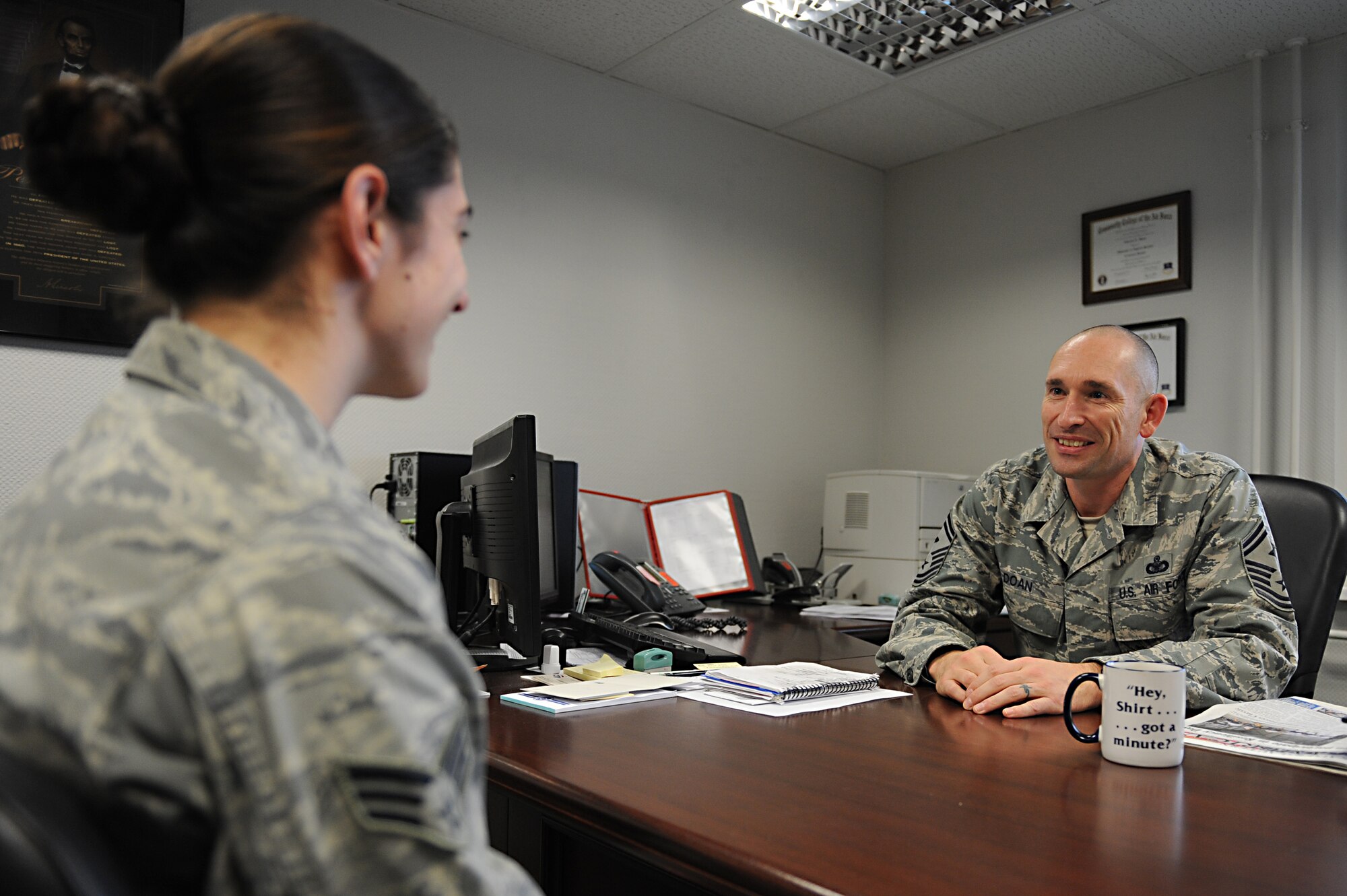 Senior Airman Sarah Root, 86th Aeromedical Squadron flight medicine technician, speaks to Senior Master Sgt. Charles Doan, 86th Medical Group first sergeant, in his office on Ramstein Air Base, Germany, Nov. 16, 2012. The first sergeants use knowledge, experience and skill to guide Airmen in the right direction around the Air Force. (U.S. Air Force photo/Airman 1st Class Holly Cook)