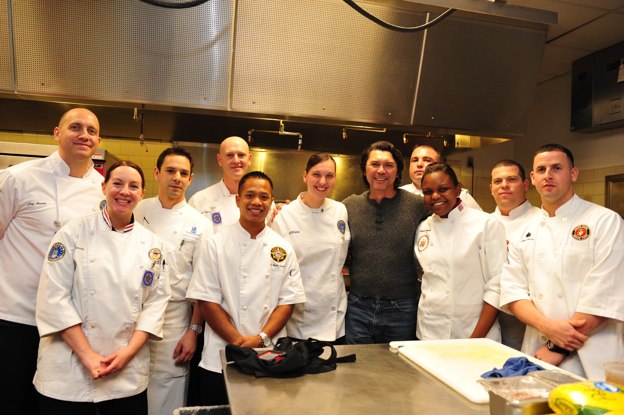 Army Spc. Kevin Arwood, Air Force Master Sgt. Jennifer Shown, Ritz Executive Chef Jose Fernandez, Army Staff Sgt. Gabriel Aquilano, Coast Guard Petty Officer 1st Class Kevin Saiyasak, Air Force Tech. Sgt. Sarah Morgan, actor Lou Diamond Phillips, Navy Chief Petty Officer Josh Ryan, Navy Petty Officer 2nd Class Sherrol Samuels, Army Spc. Javier Muniz and Marine Corps Gunnery Sgt. Pedro Marrerocruz pause during food preparation at the USO Salute to Military Chefs, Nov. 14. The USO of Metropolitan Washington has celebrated the skills and talents of military chefs at the annual gala since 1997. (USO photo by Jeff Kline)