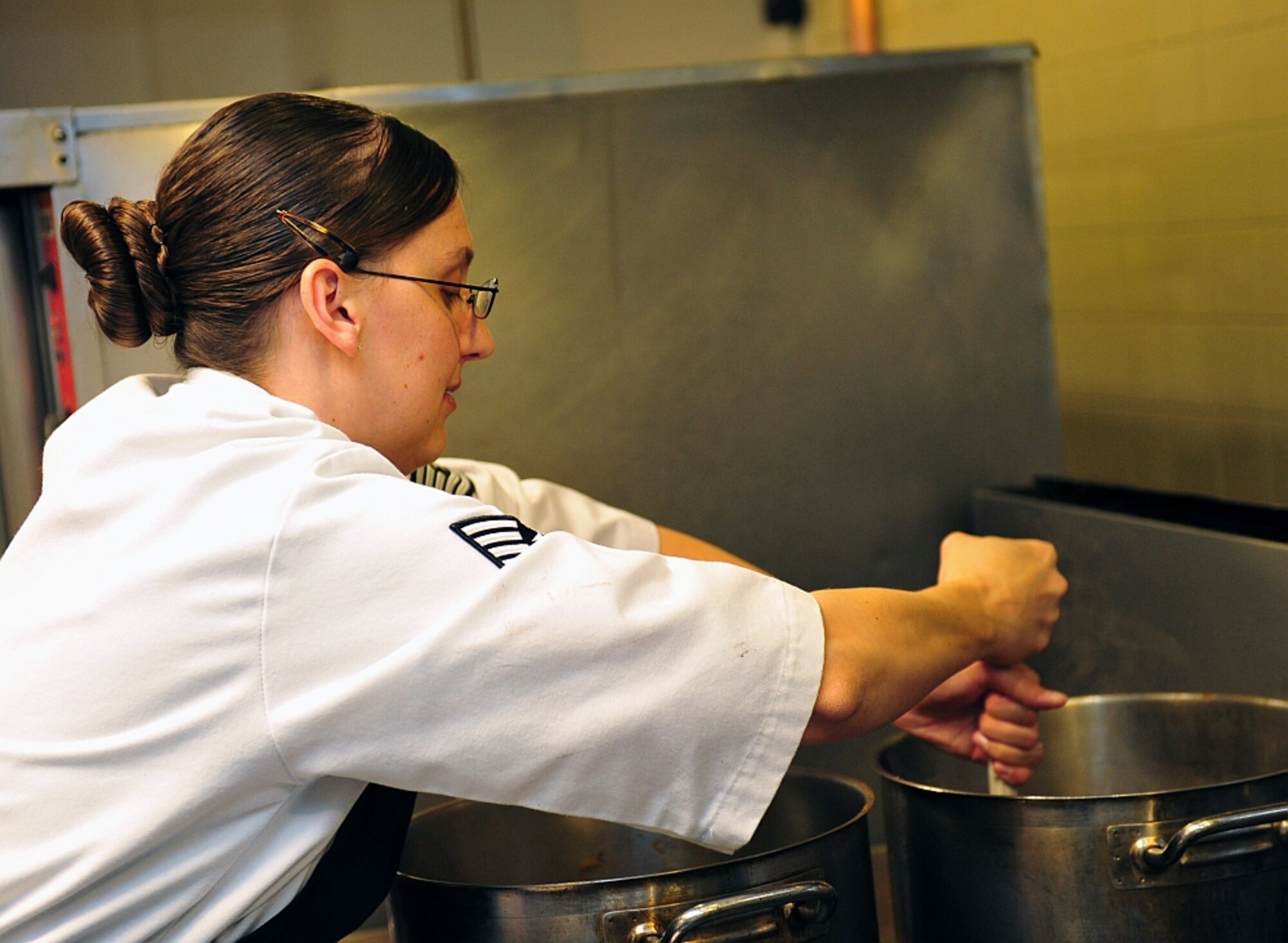 Tech. Sgt. Sarah Morgan, enlisted aide to the commander, Air Force Global Strike Command, prepares a soup dish to be served at the Salute to Military Chefs event Nov. 14 at the Ritz-Carlton in Pentagon City, Va. Morgan represented the Air Force in the annual USO of Metropolitan Washington-hosted event, which showcases the culinary talents of military chefs. (Photo by JD Kline)