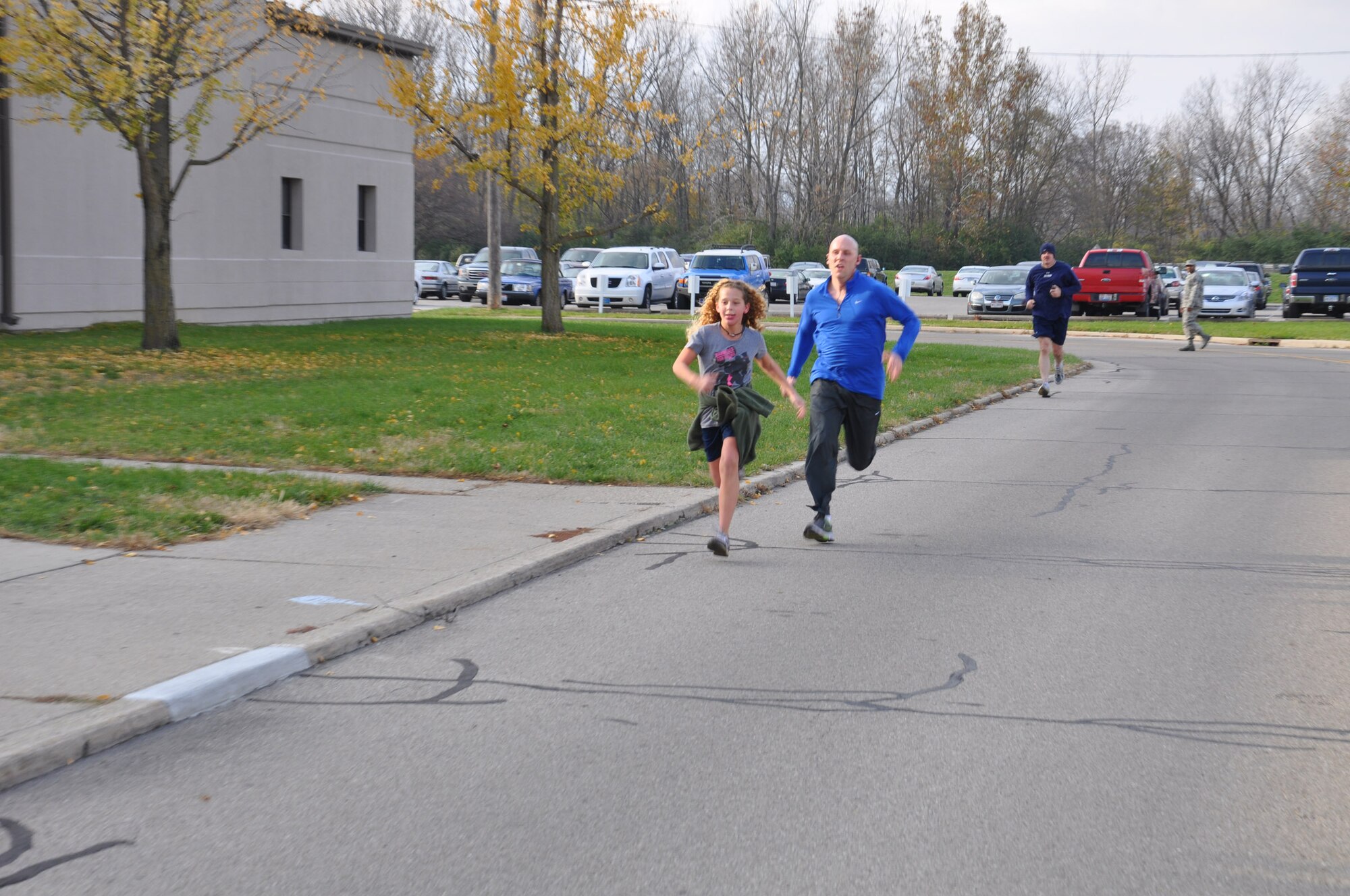 WRIGHT-PATTERSON AIR FORCE BASE, Ohio –Alora Penner, daughter of Master Sgt. Kerry Penner, 445th Maintenance Group quality assurance inspector, crosses the finish line, winning first place in the women’s category in the 445th Airlift Wing Combined Federal Campaign 5K run Nov. 4. More than 40 runners participated in the event. The wing met its 2012 CFC goal by raising $15,537.90. (U.S. Air Force photo/Staff Sgt. Robert Nelson)