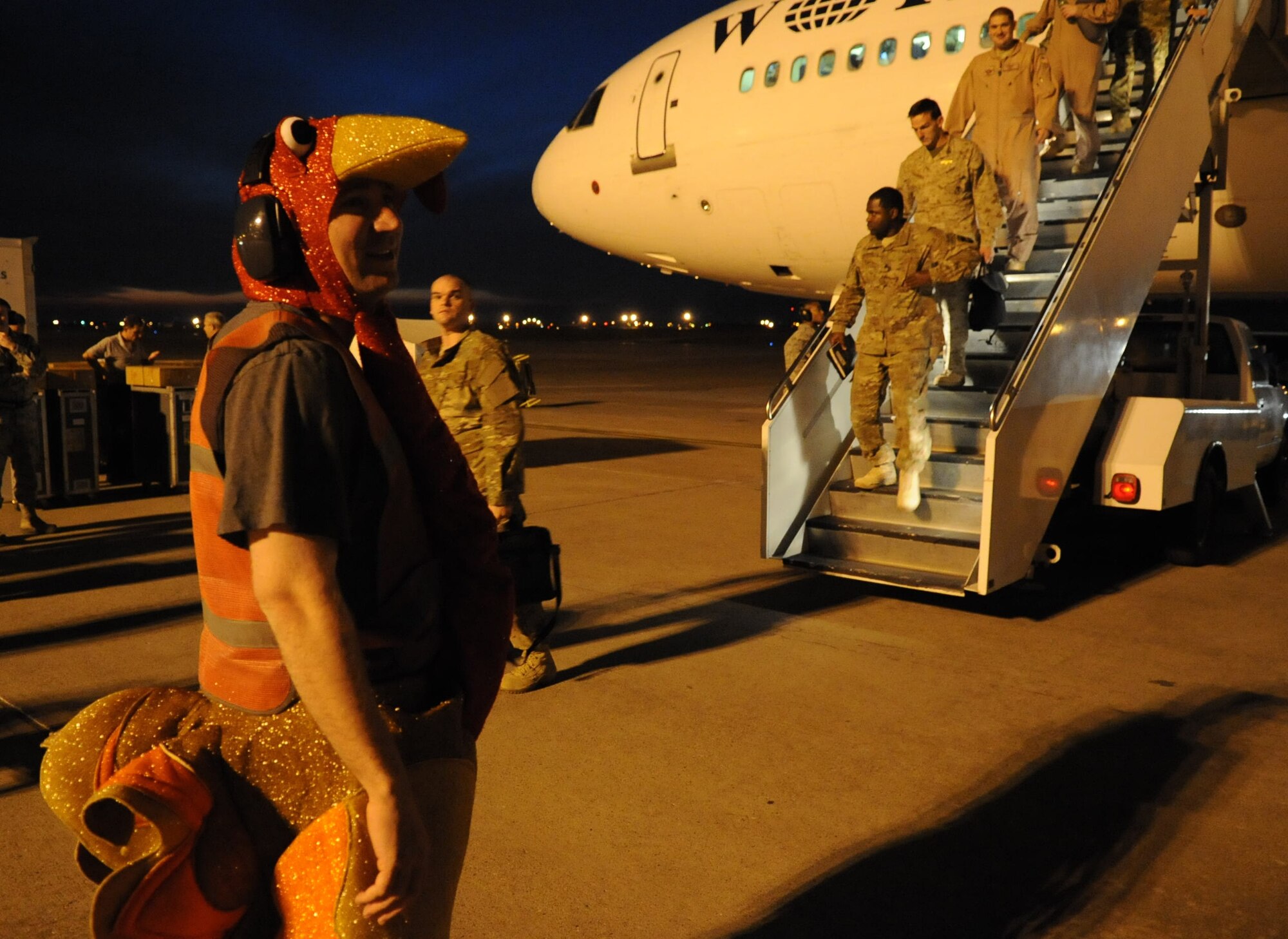 Tech. Sgt. Michael Nix, 728th Air Mobility Squadron assistant section chief, gets ready to greet transient deployers dressed as a turkey to bring some Thanksgiving cheer as they stop at Incirlik Air Base, Turkey Nov. 16, 2012. The jet stopped at Incirlik to change out the air crew, refuel and dropp off new arrivals before continuing on to the deployment location. (U.S. Air Force photo by Senior Airman Daniel Phelps/Released)