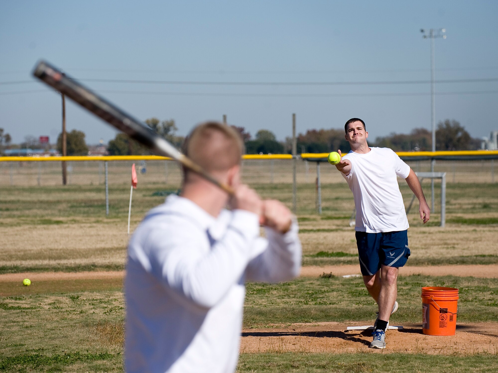 Tech. Sgt. Jason Wilkin, 2nd Contracting Squadron, pitches a ball to Airman 1st Class Kristopher Tolar, 2 CONS, during the homerun derby on Barksdale Air Force Base, La., Nov. 16. The derby was part of the 2012 Sports Day, an annual event that gives Airmen the opportunity to participate in several individual and team sports throughout the day. (U.S. Air Force photo/Staff Sgt. Chad Warren)(RELEASED)