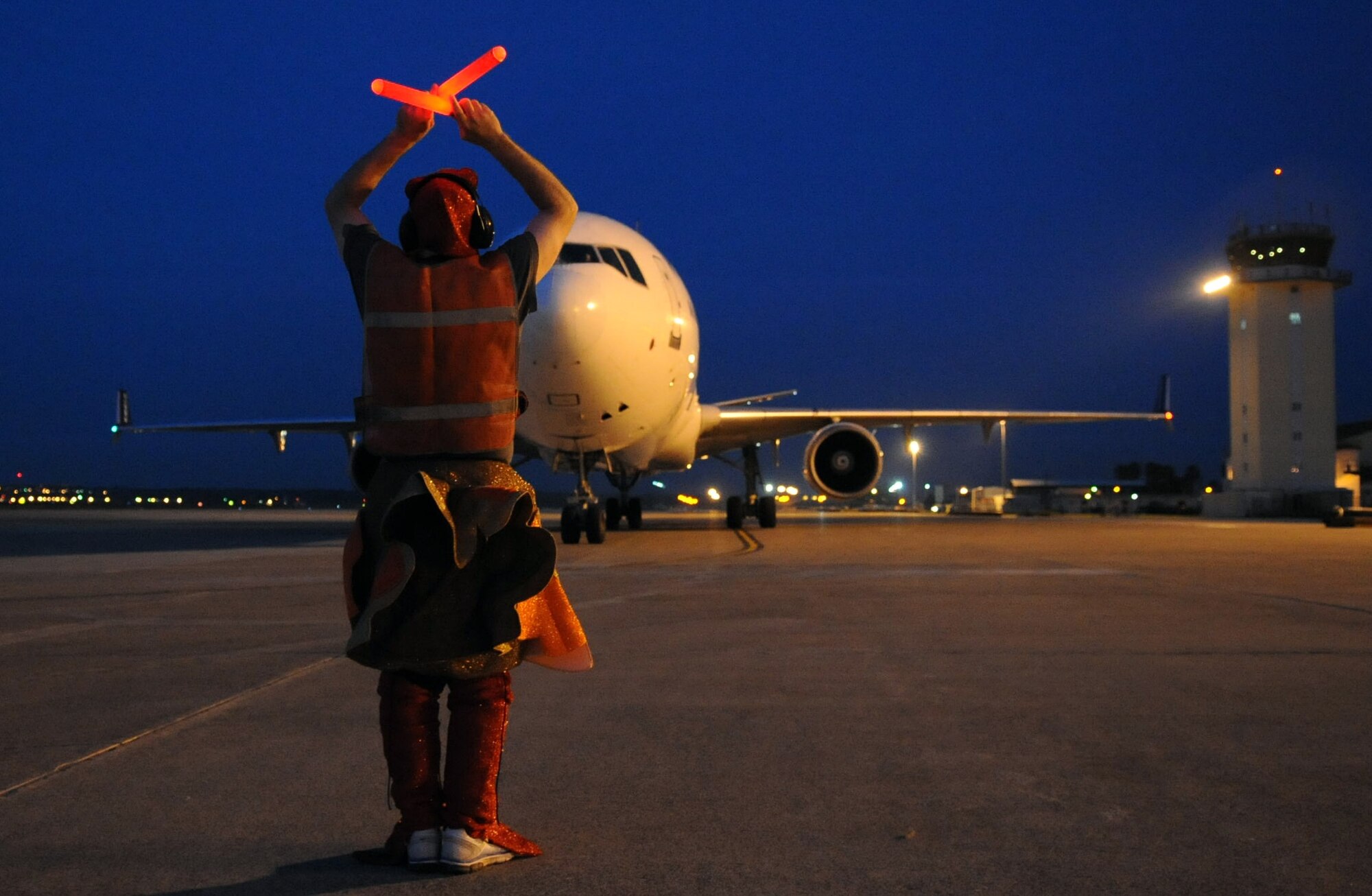 Tech. Sgt. Michael Nix, 728th Air Mobility Squadron assistant section chief, marshals the Patriot Express dressed as a turkey to bring some Thanksgiving cheer as they stop at Incirlik Air Base, Turkey Nov. 16, 2012. The jet stopped at Incirlik to change out the air crew, refuel and drop off new arrivals before continuing on to the deployment location. (U.S. Air Force photo by Senior Airman Daniel Phelps/Released)