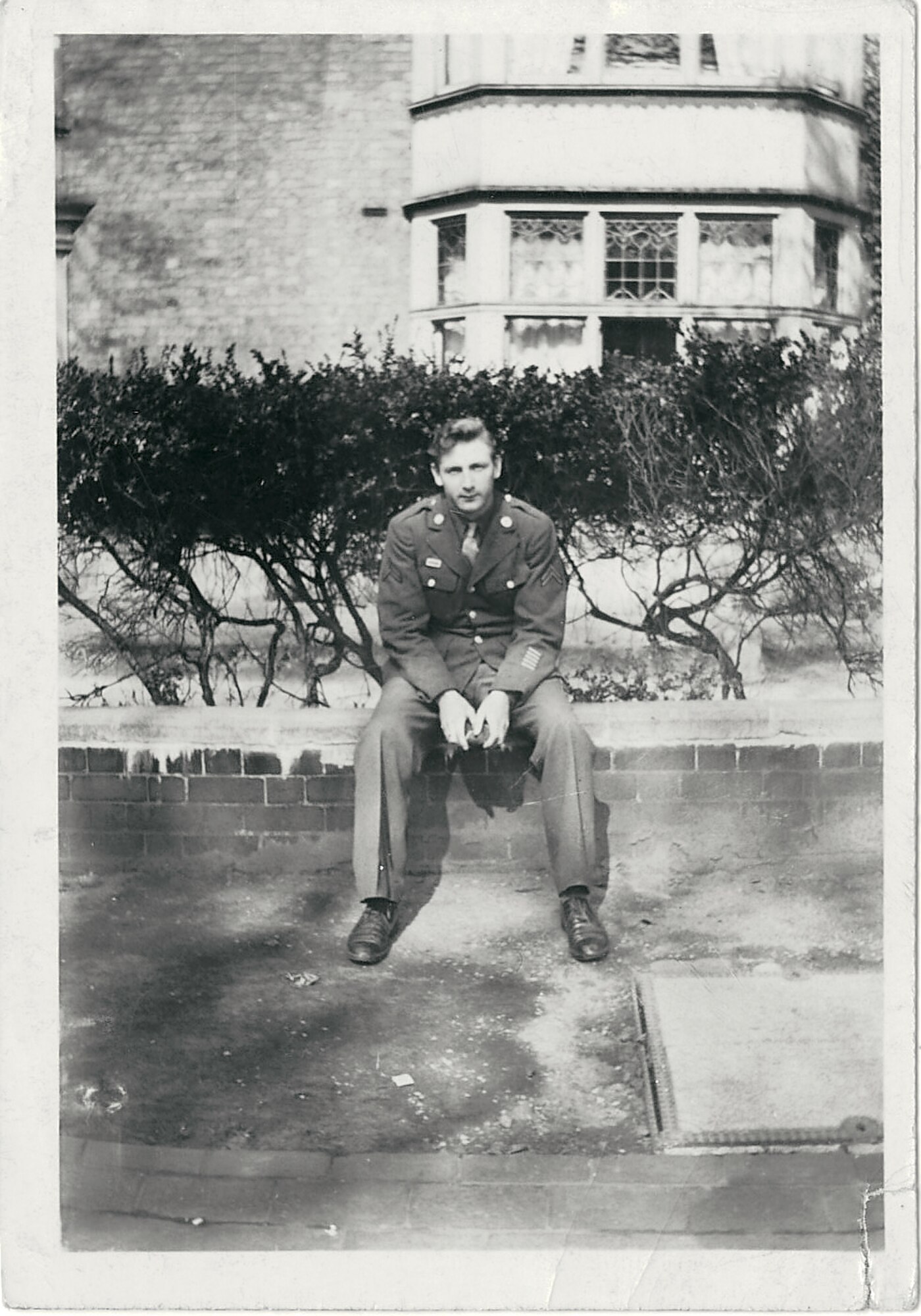 RAF ALCONBURY, United Kingdom - Ted Penn sits in front of Alconbury House while assigned to the 685th Air Materiel Squadron at RAF Alconbury during World War II. His squadron worked out of temporary buildings in front of Alconbury House during the war, and Penn visited RAF Alconbury Nov. 13, 2012, for the first time in 67 years. (Courtesy Photo)