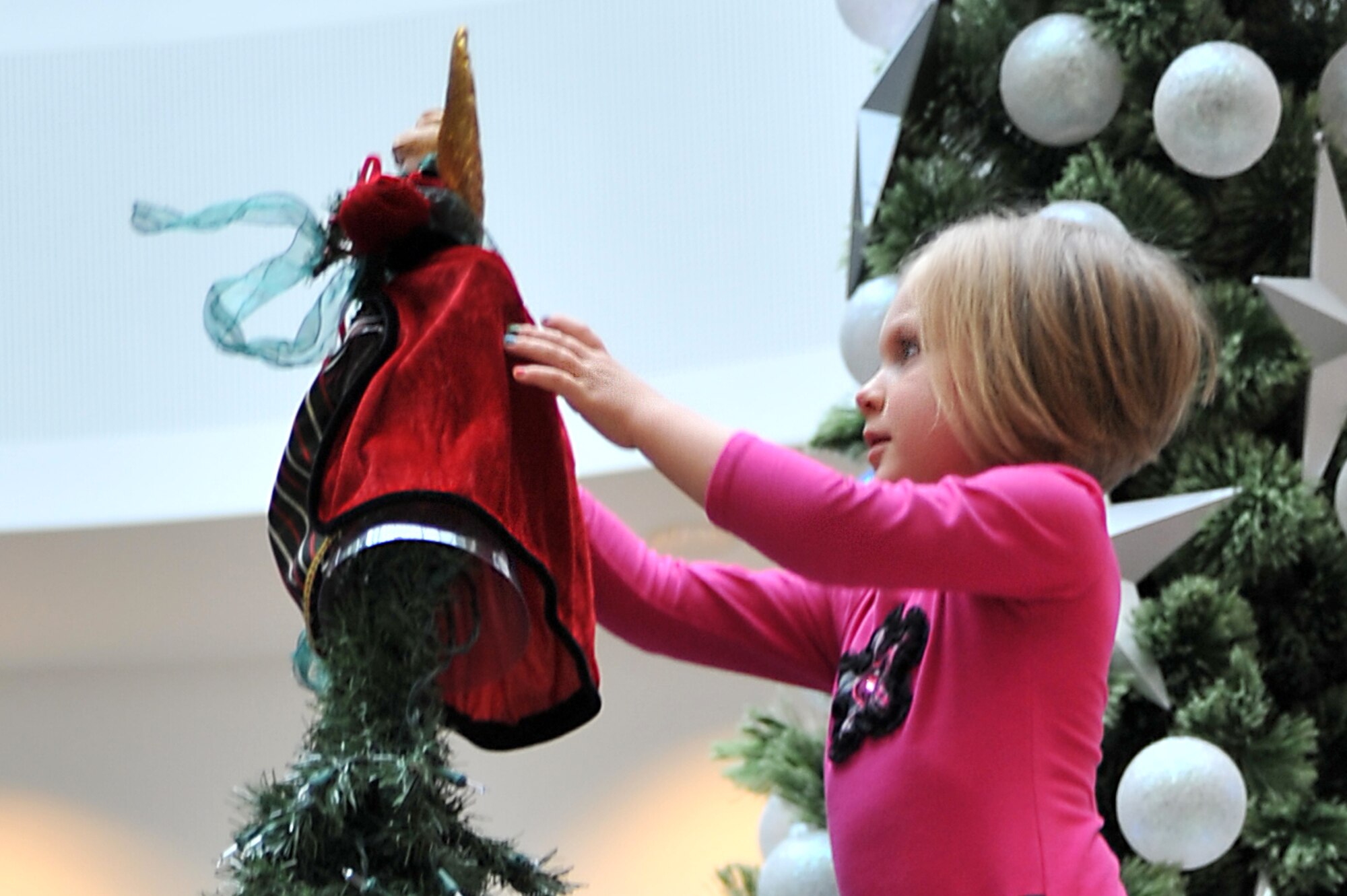 Audrey McNabb, 3-year-old daughter of Tech. Sgt. Jason McNabb, 435th Contingency Response Group, crowned this year’s angel tree with its angel on Ramstein Air Base, Germany, Nov. 16, 2012. The Angel Tree program provides financial relief which helps in the purchase of gifts for children during the holiday season. (U.S. Air Force photo/Senior Airman Caitlin O’Neil-McKeown)